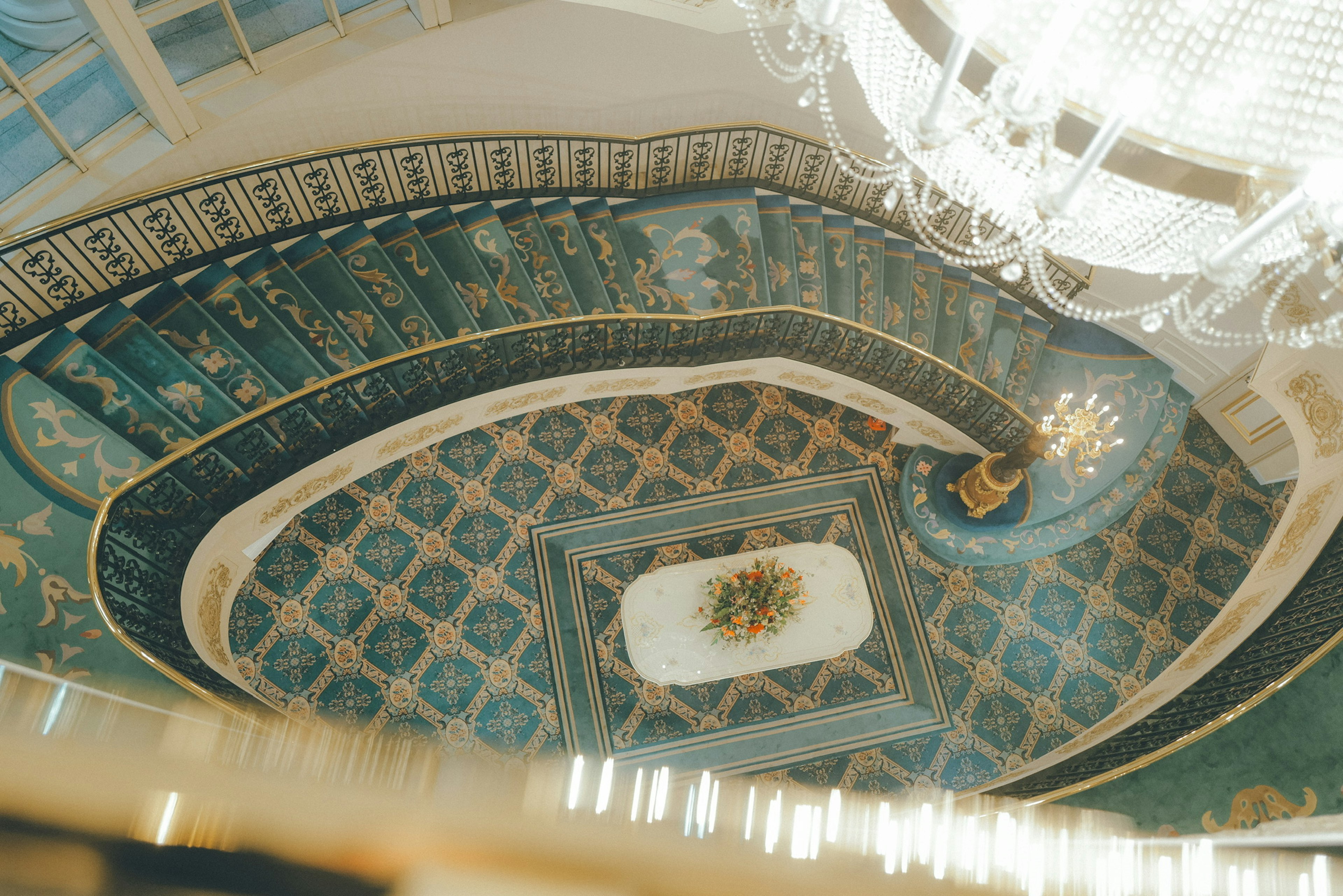 Elegant spiral staircase with a luxurious chandelier