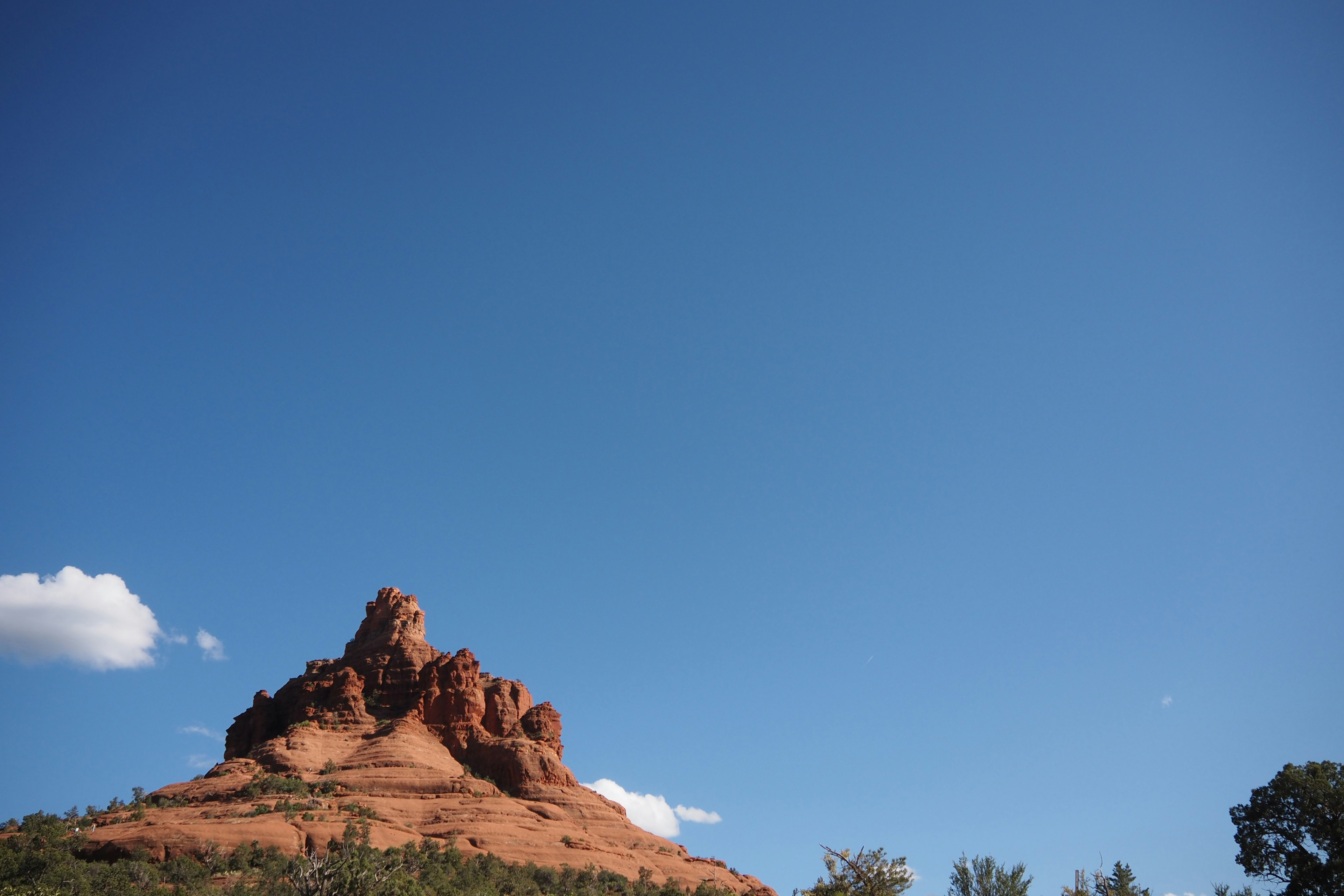 Red rock formation under a clear blue sky