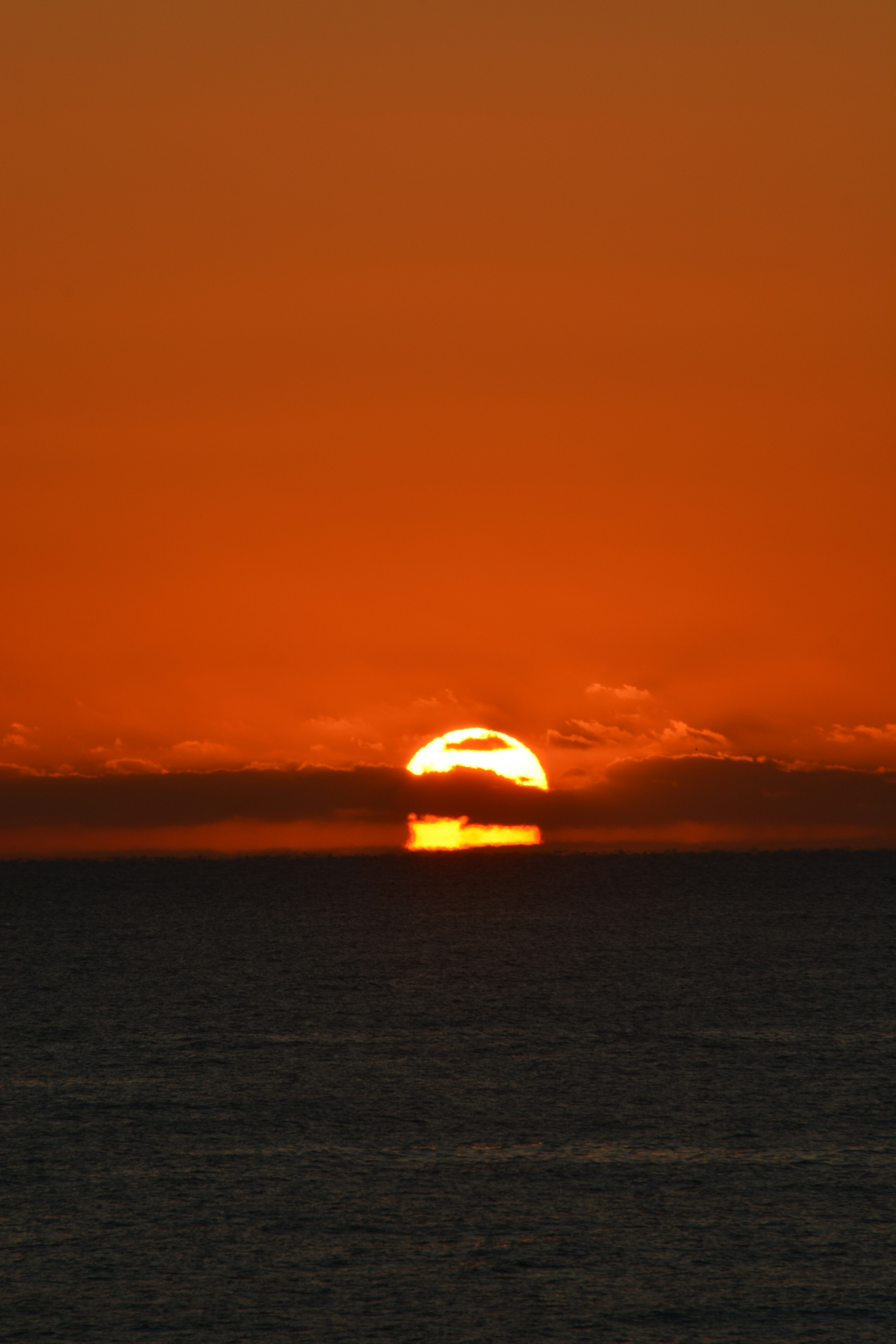 Bella vista del tramonto con il sole arancione che tramonta sull'oceano