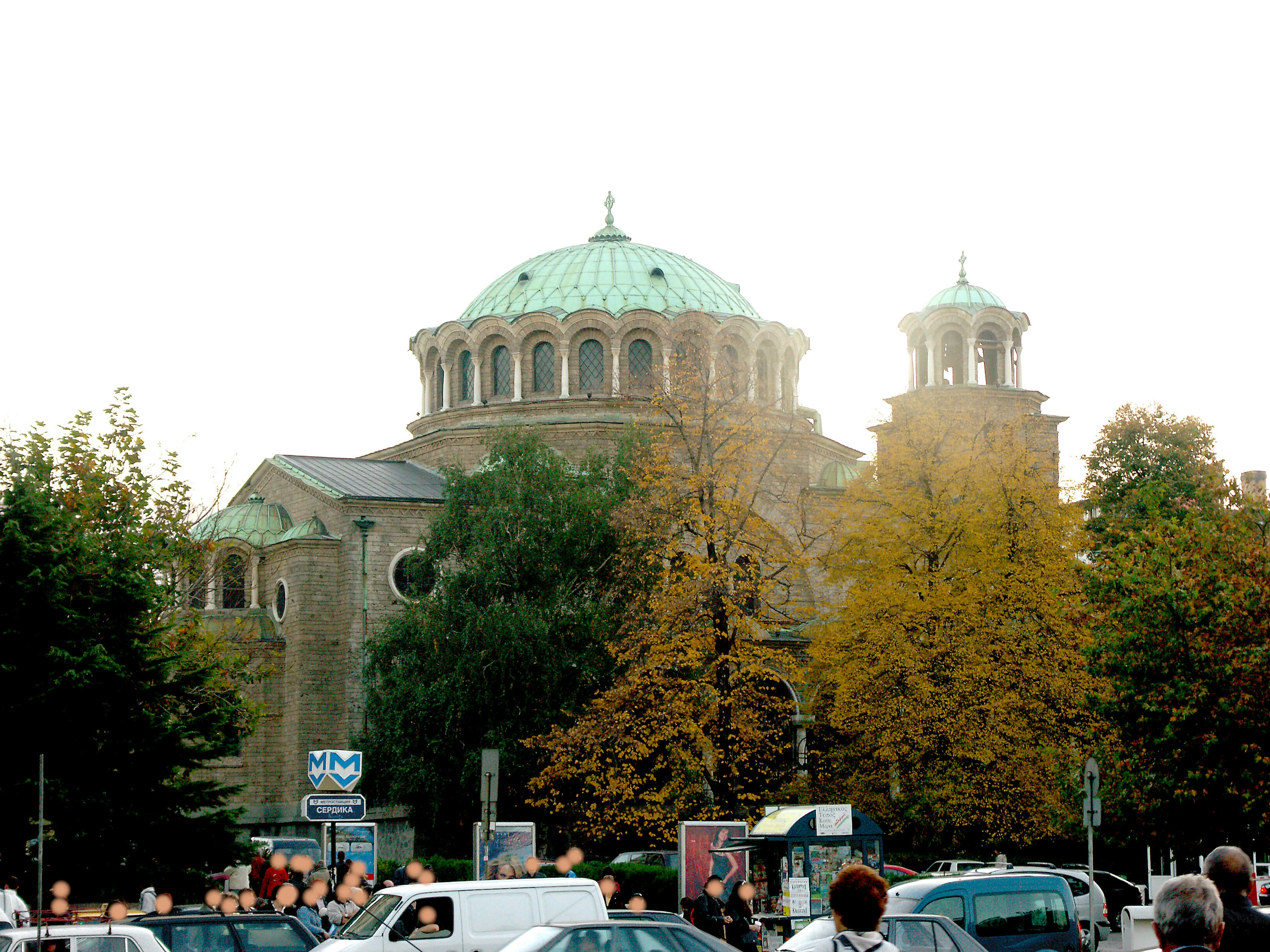 Church with a beautiful green dome and autumn trees