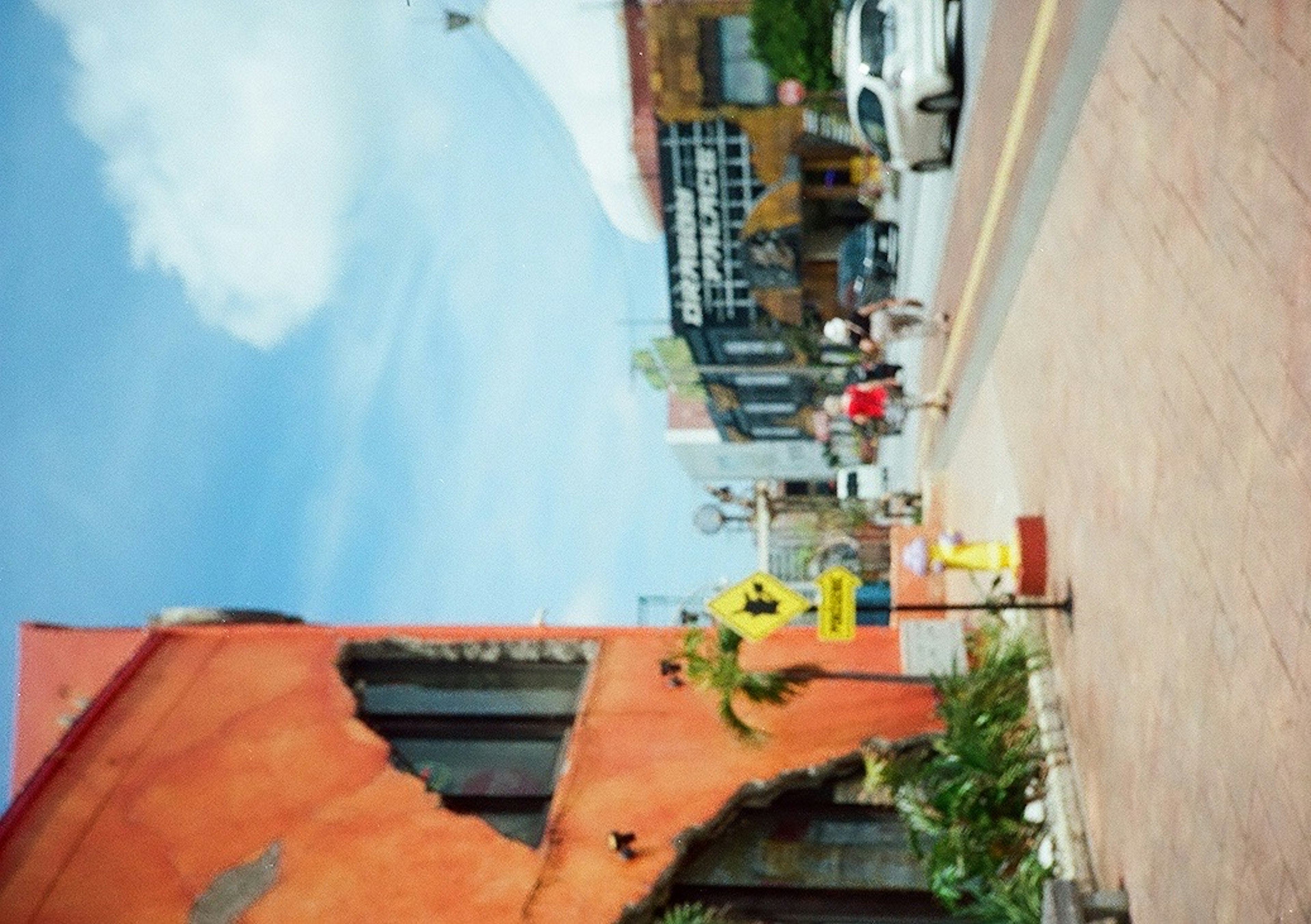 Urban scene featuring an orange building under a blue sky