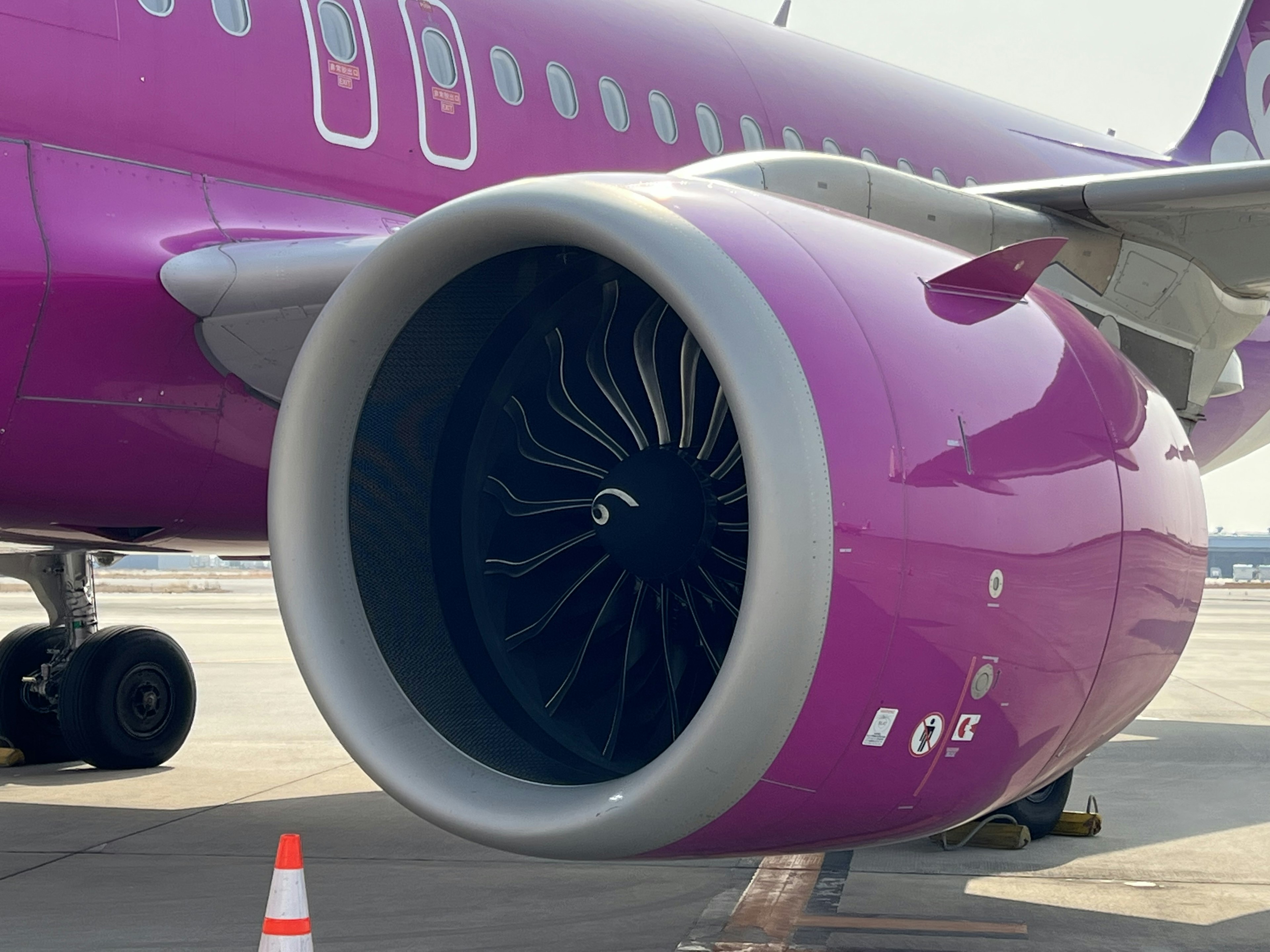 Close-up of a purple airplane engine with visible turbine blades