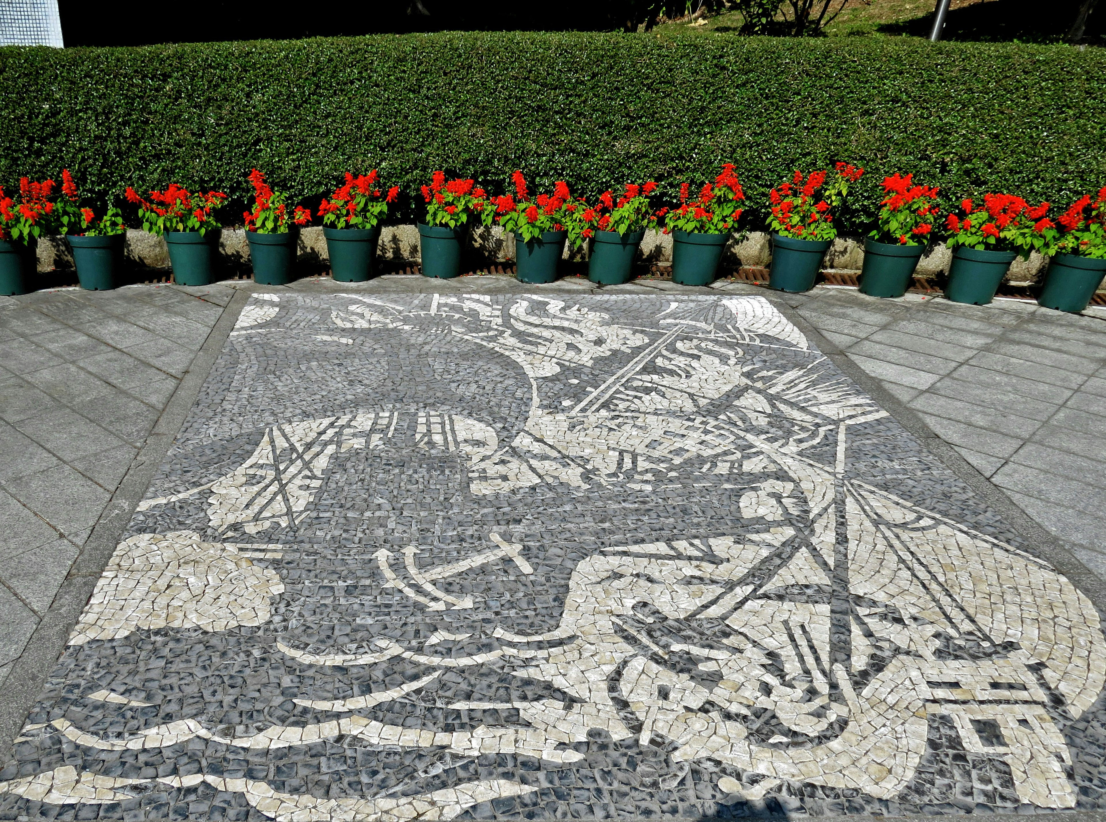 Mosaic design featuring a detailed image with colorful flower pots in the foreground