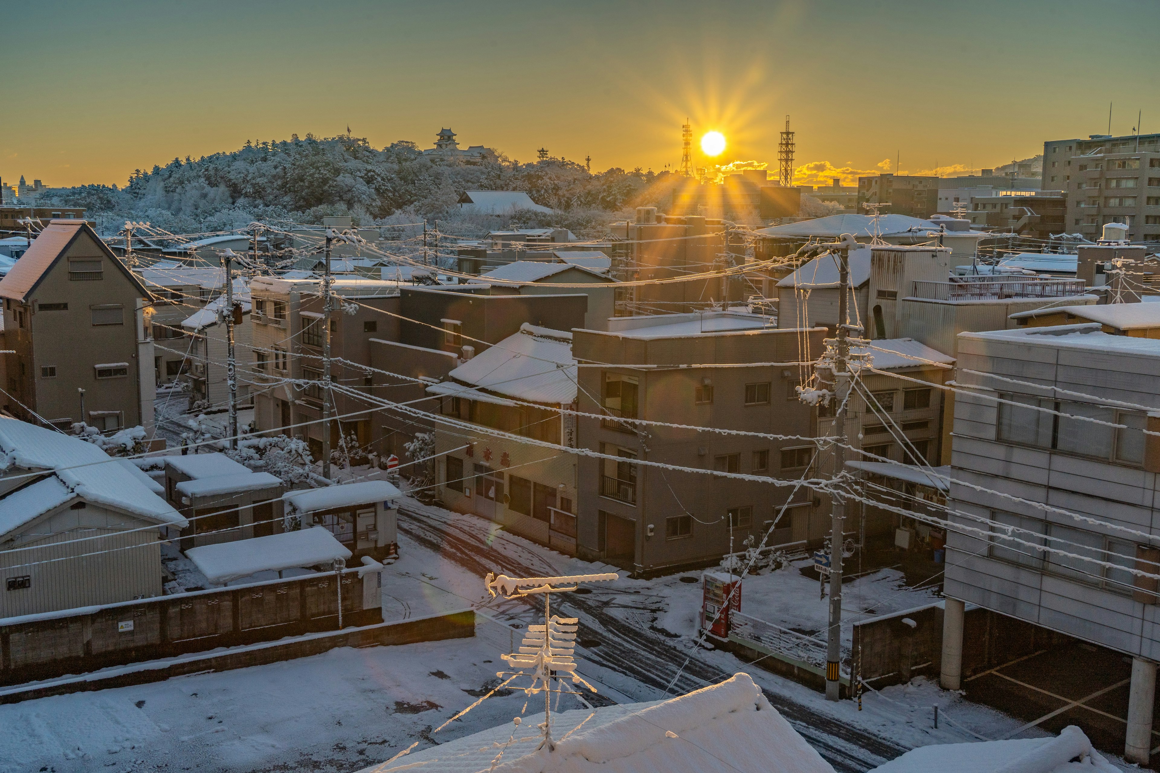 Snow-covered urban landscape at sunrise