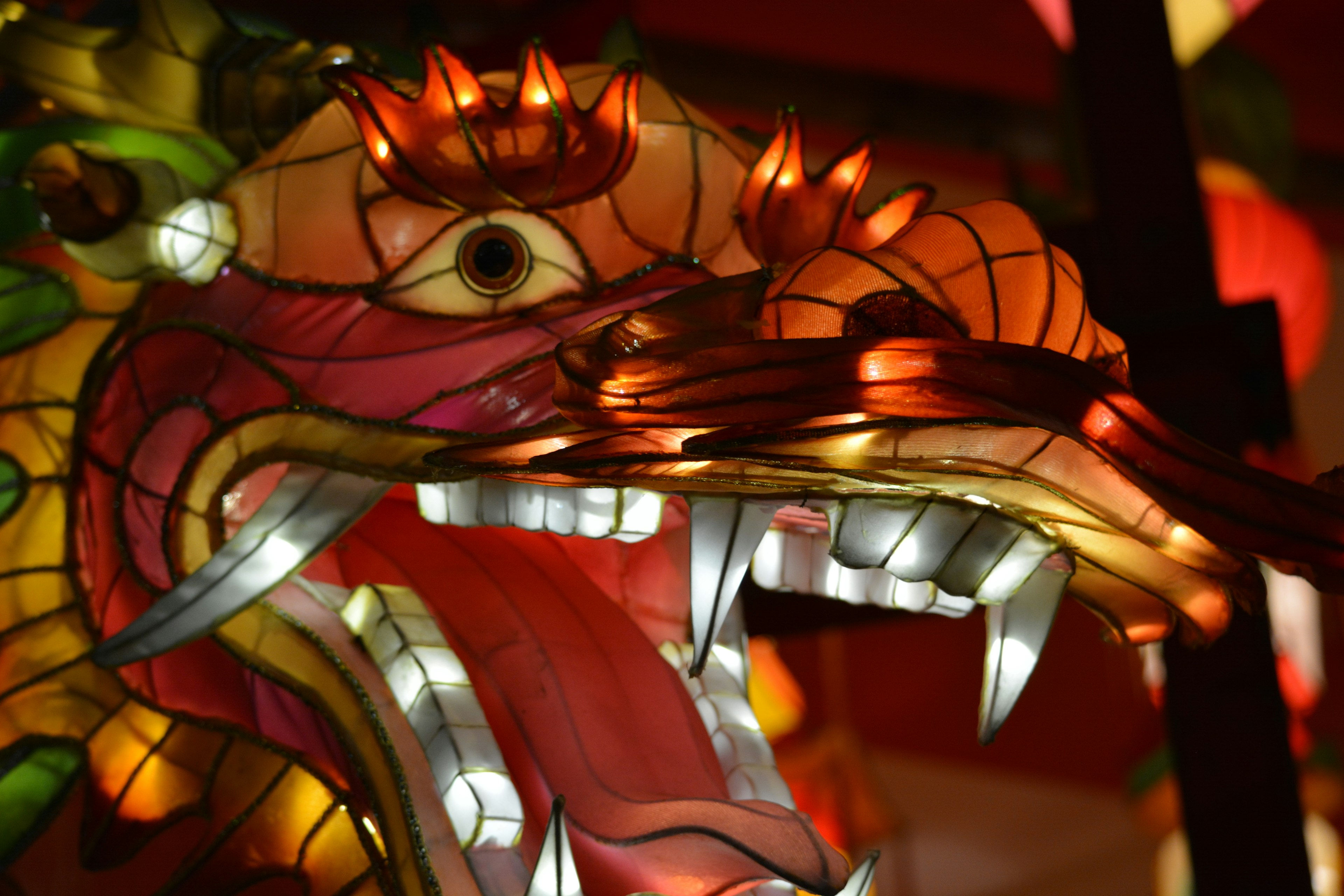 Colorful lantern dragon head with glowing eyes and sharp teeth