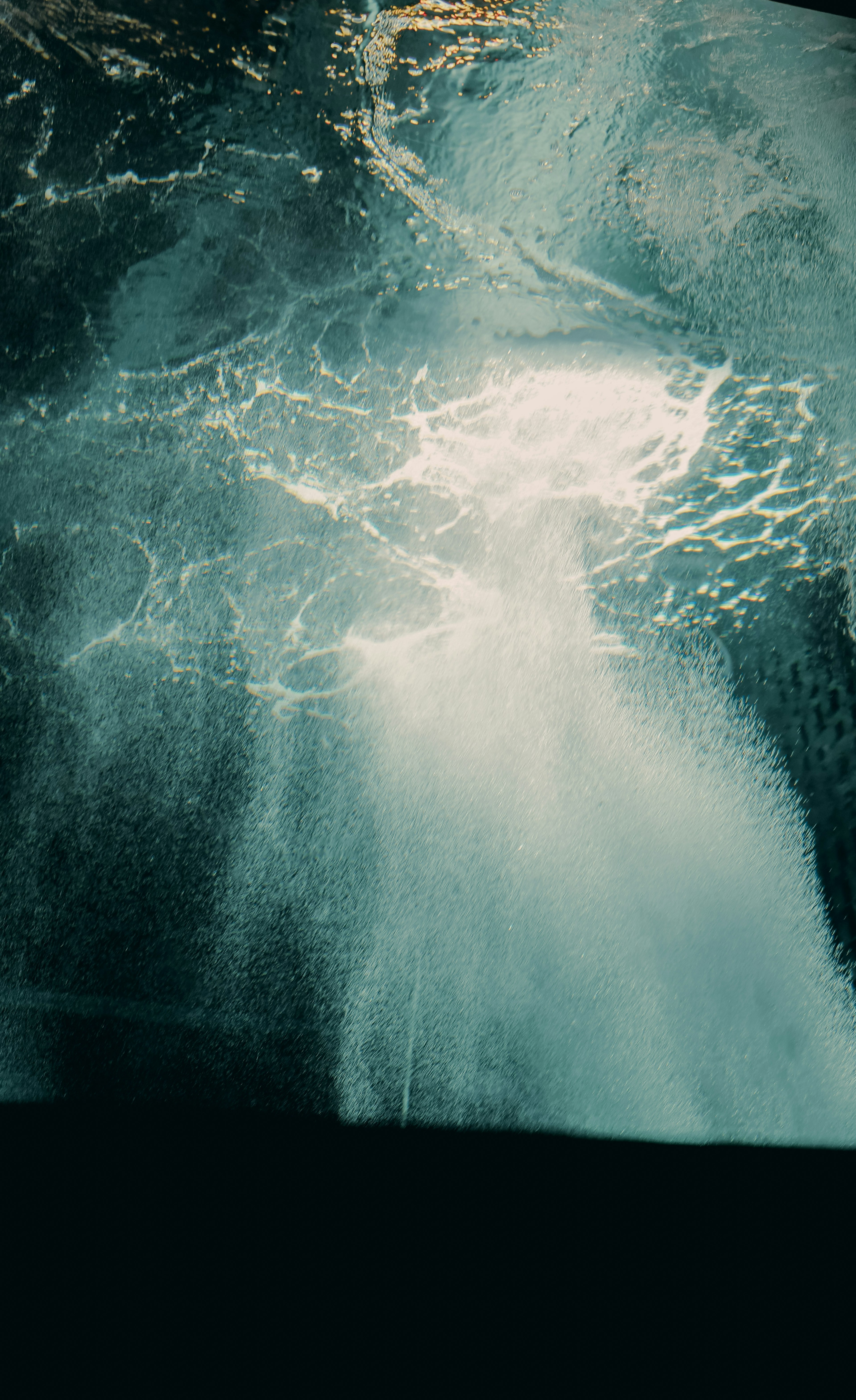 Underwater scene with bubbles and splashes rising from a dark surface