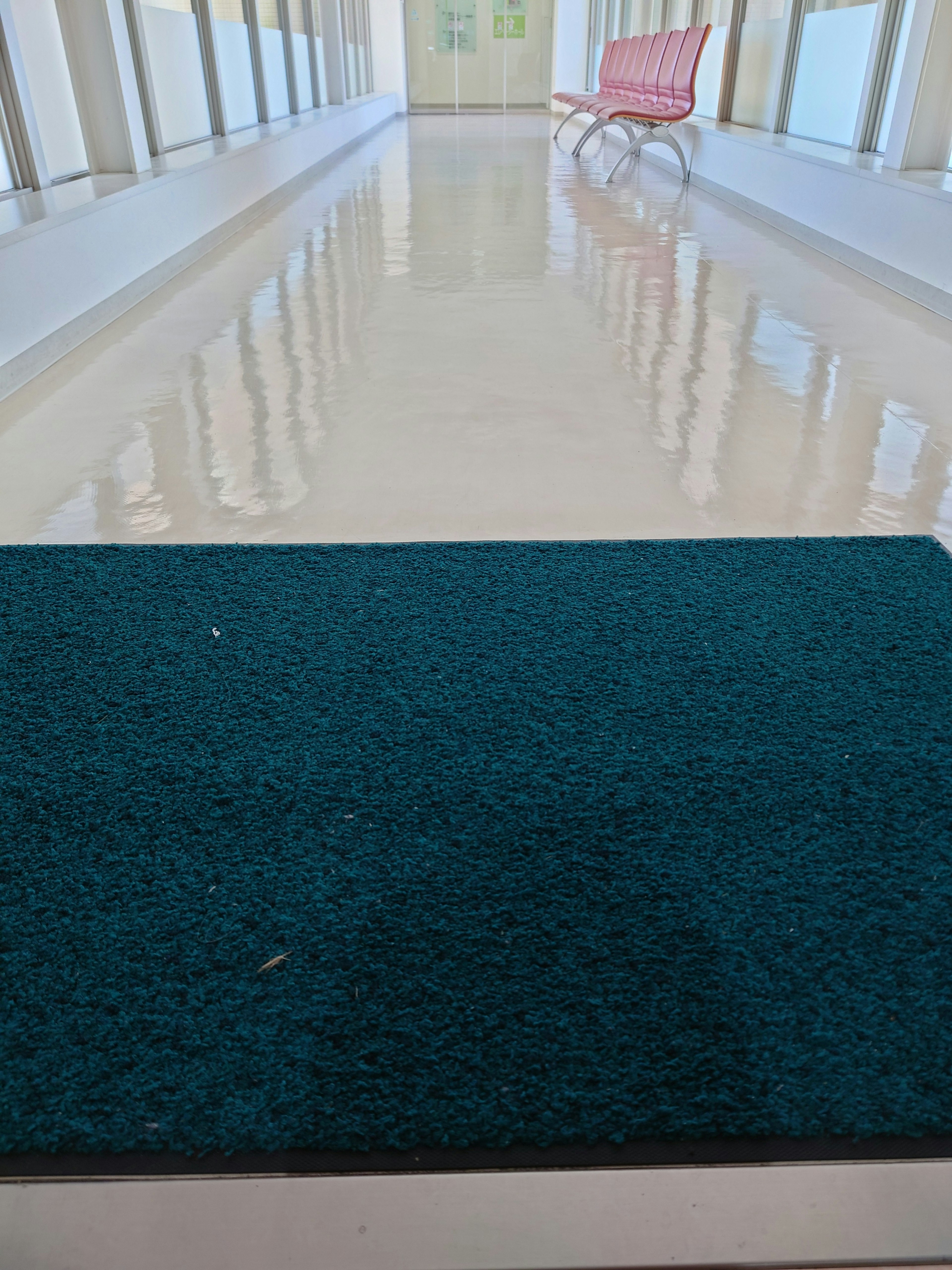 Image of a blue mat with a bright hallway and reflections