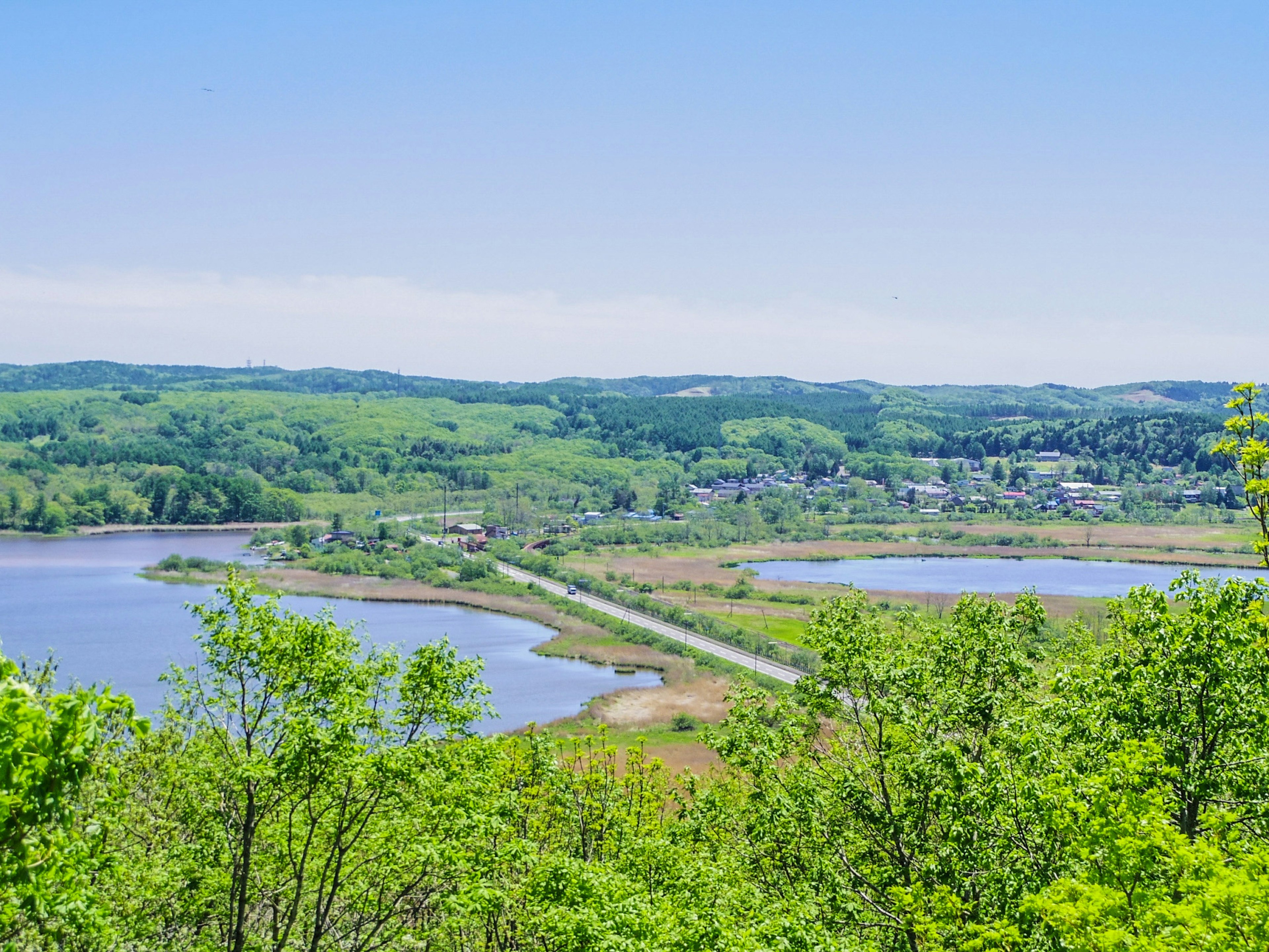 Panoramic view of lush hills and tranquil water bodies