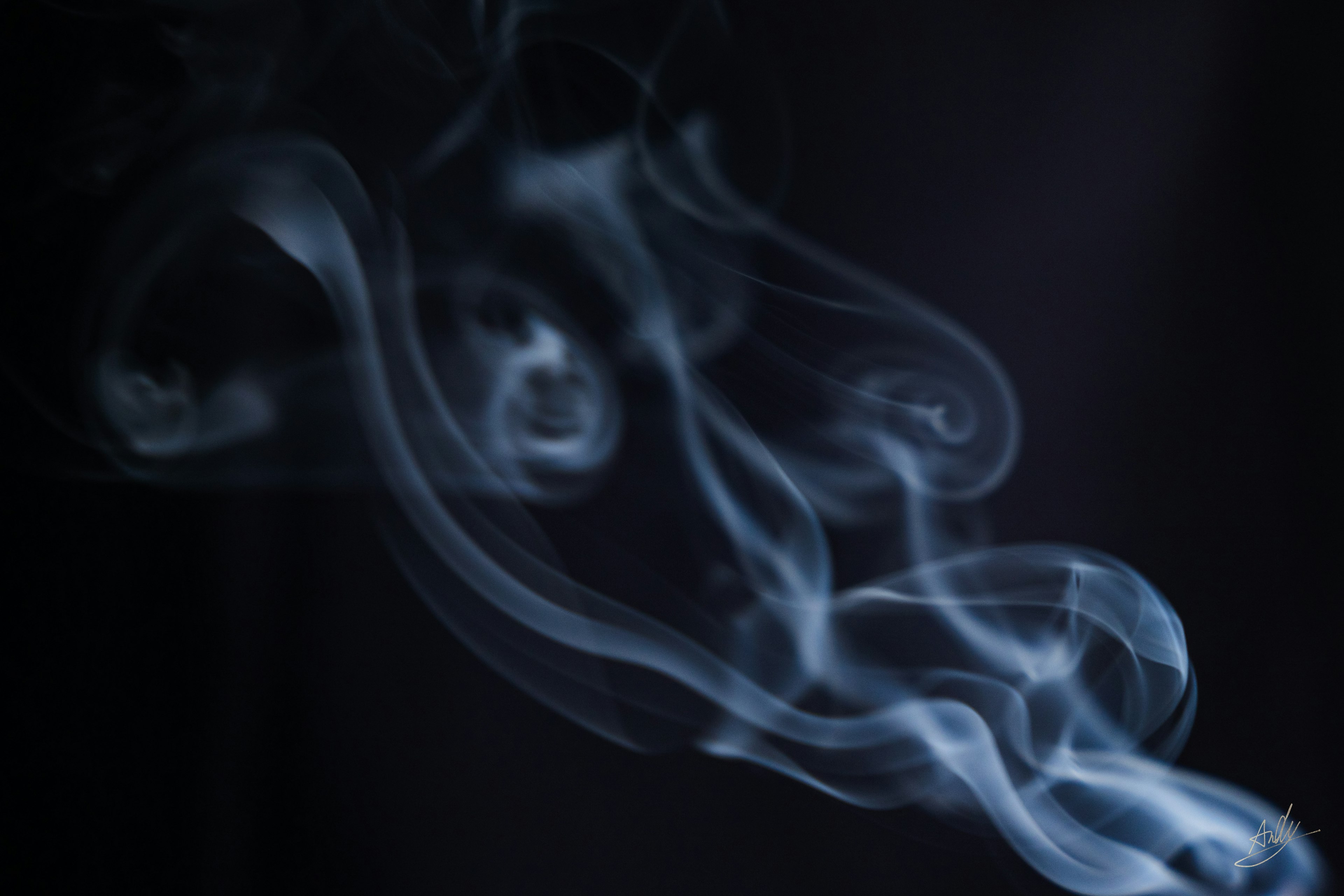 Flowing blue smoke against a black background