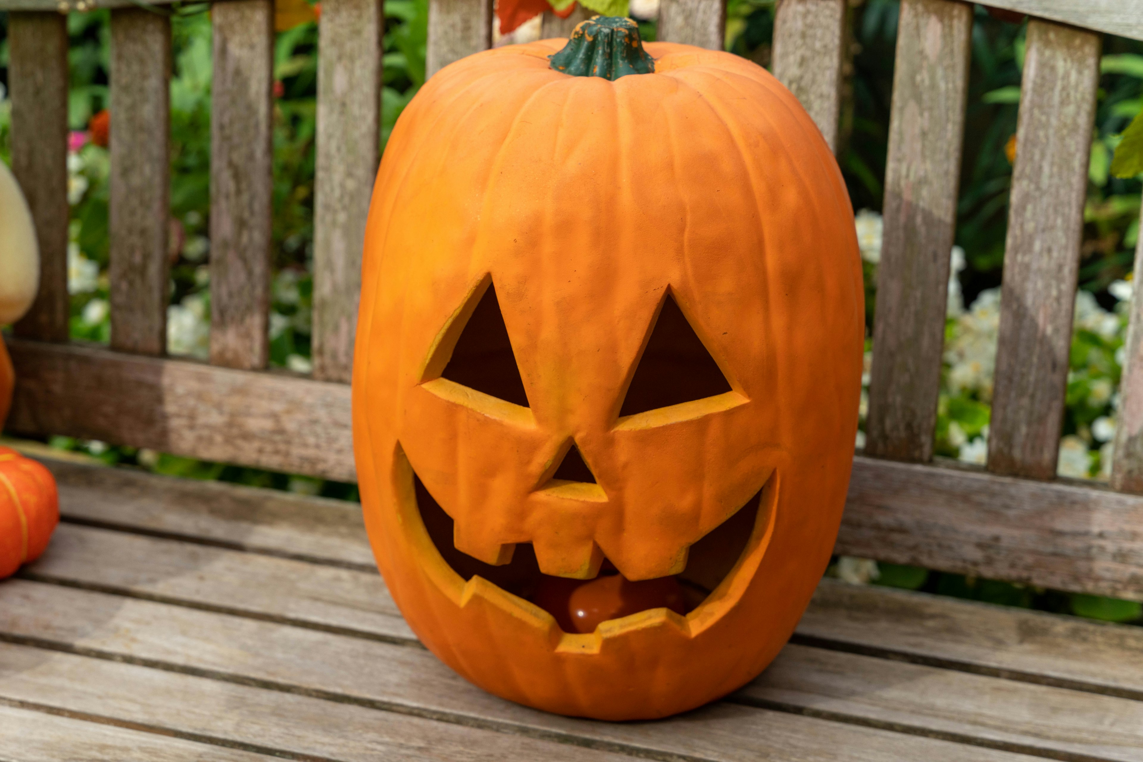 Halloween pumpkin lantern on a wooden bench