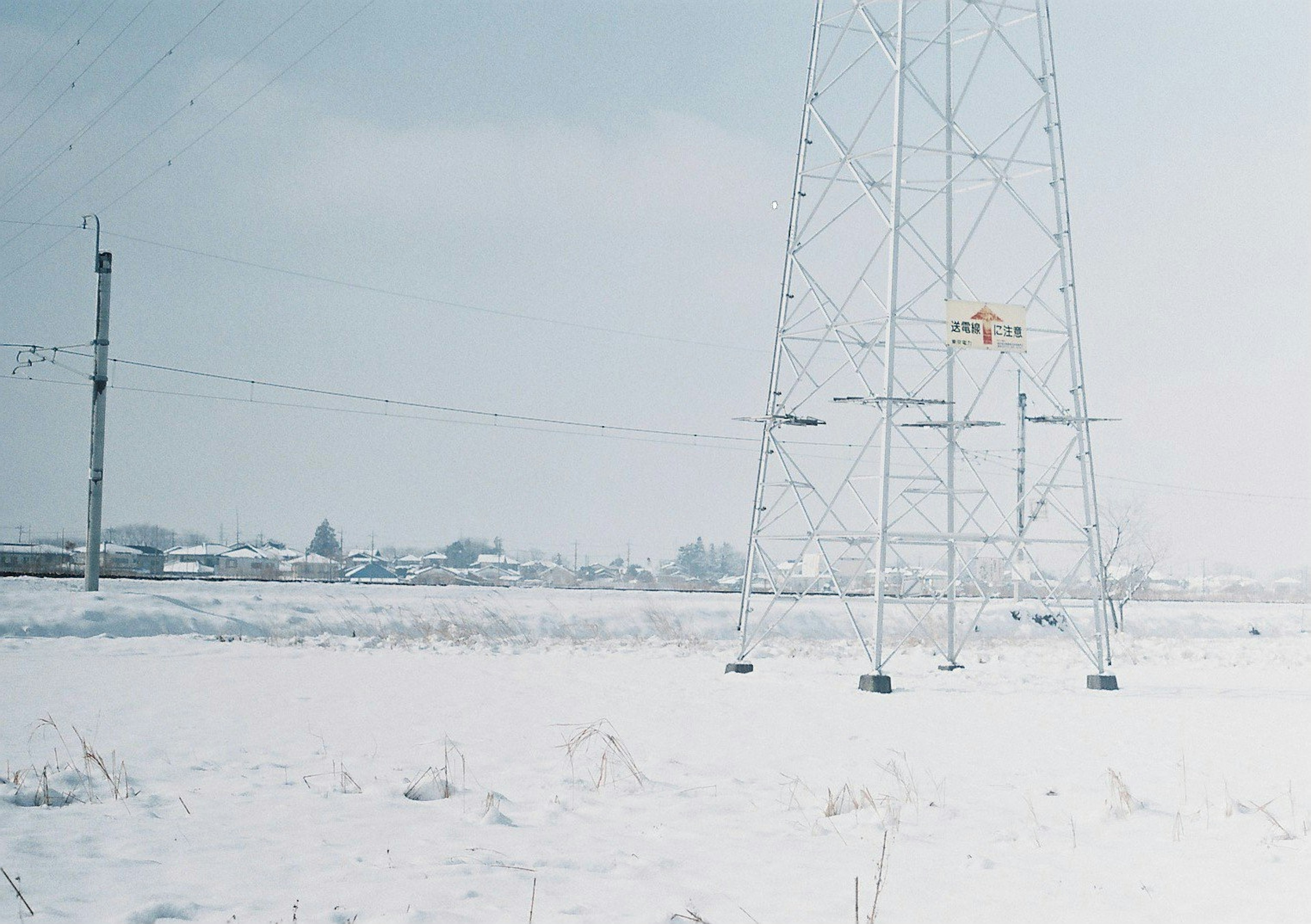 Snow-covered landscape with high-voltage power lines