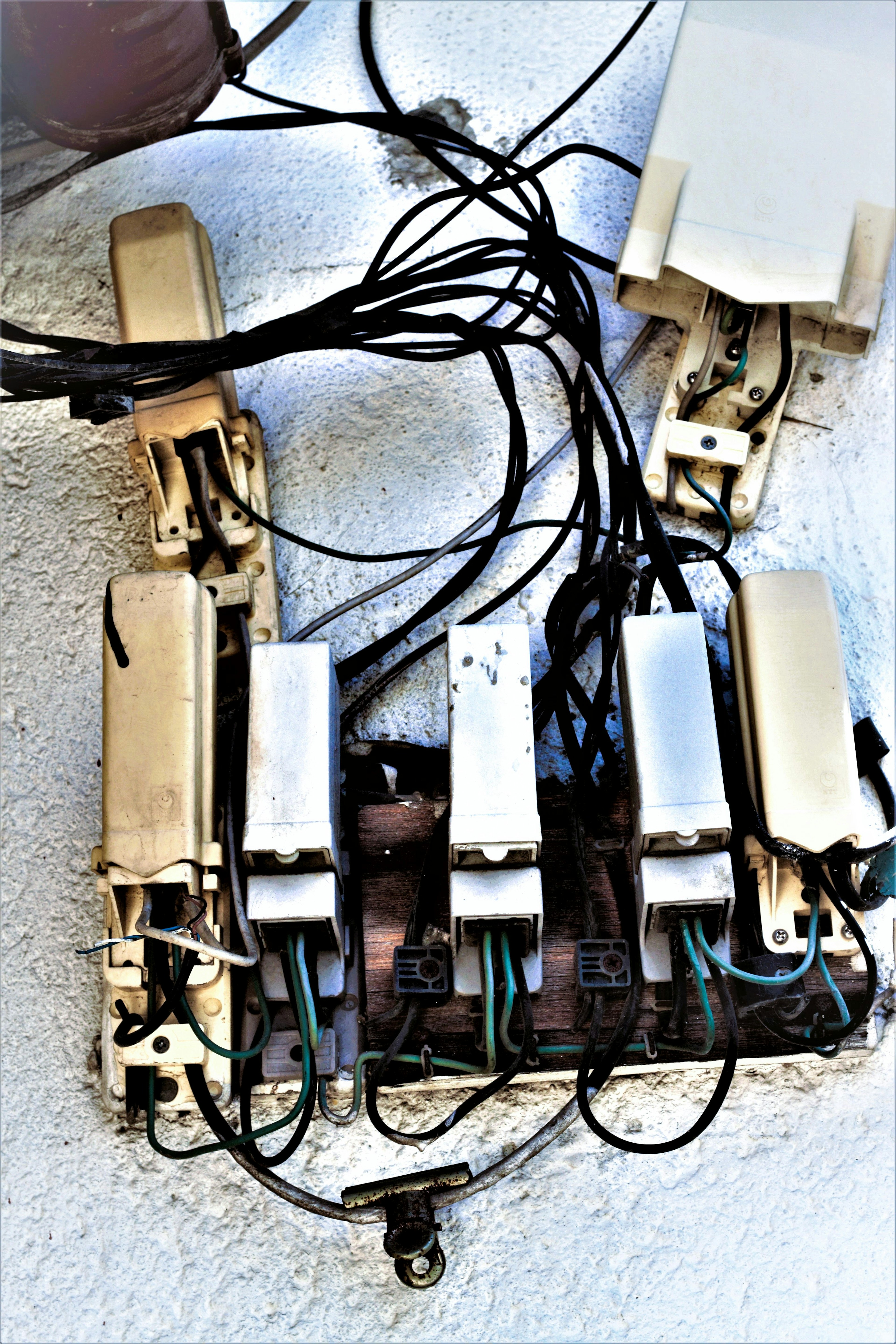 Vintage switchboard with multiple metal switches and wiring