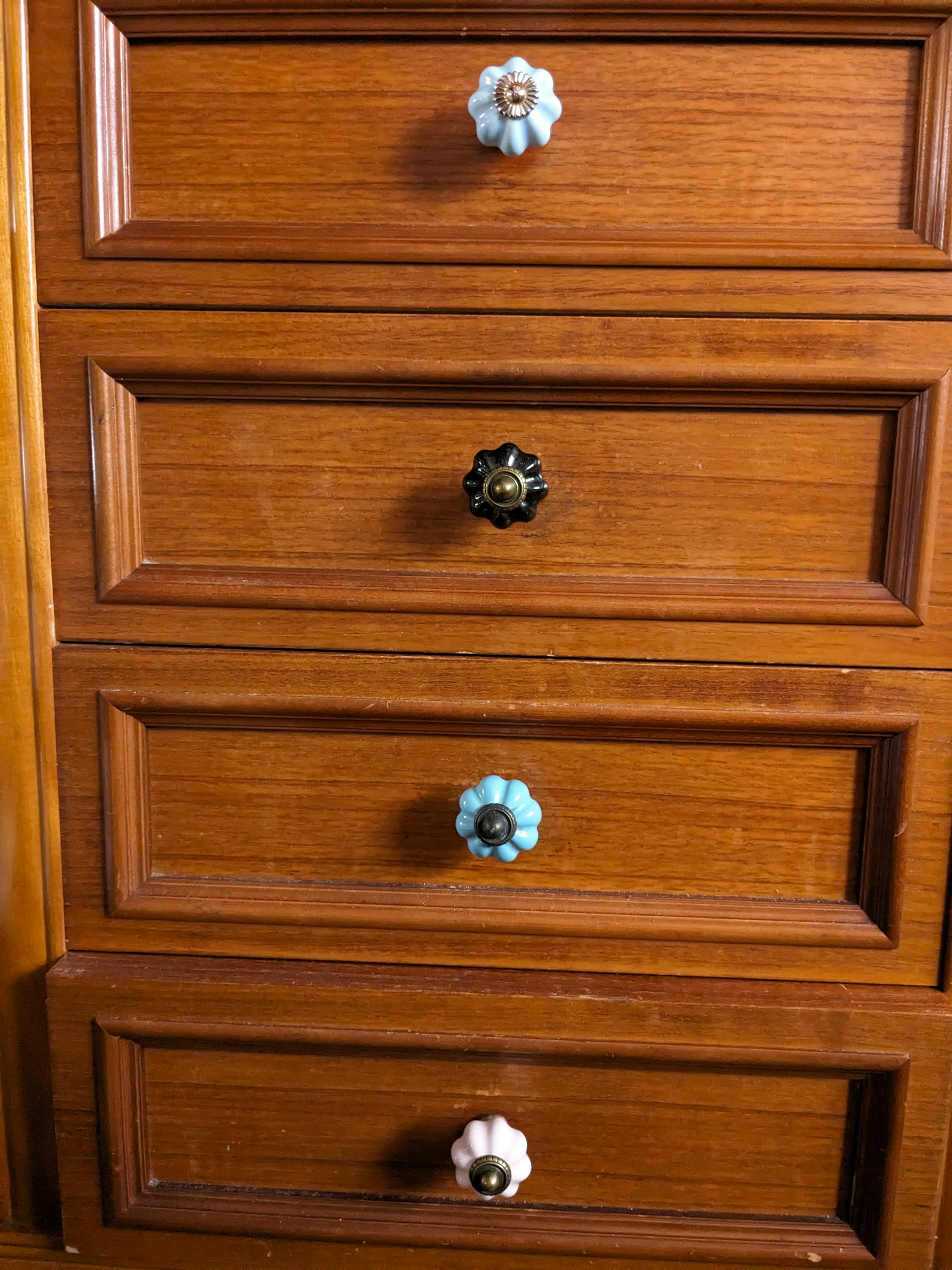 Wooden drawers featuring colorful knobs