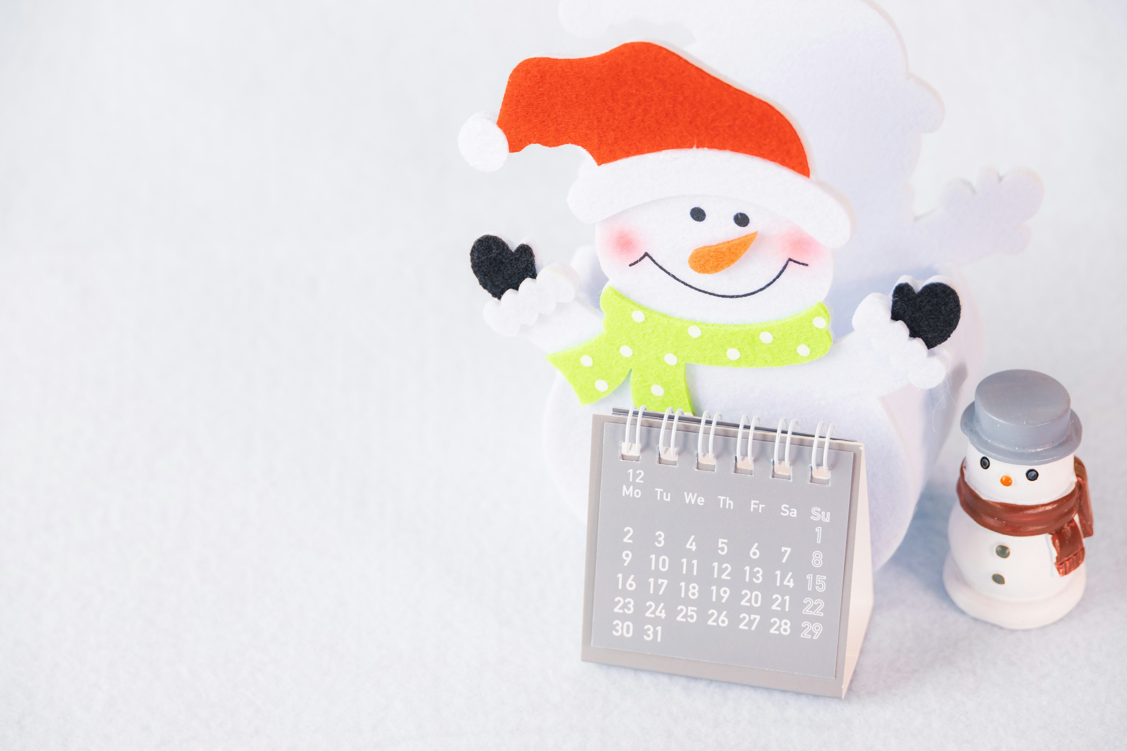 Cute snowman calendar with Santa hat and small snowman decoration