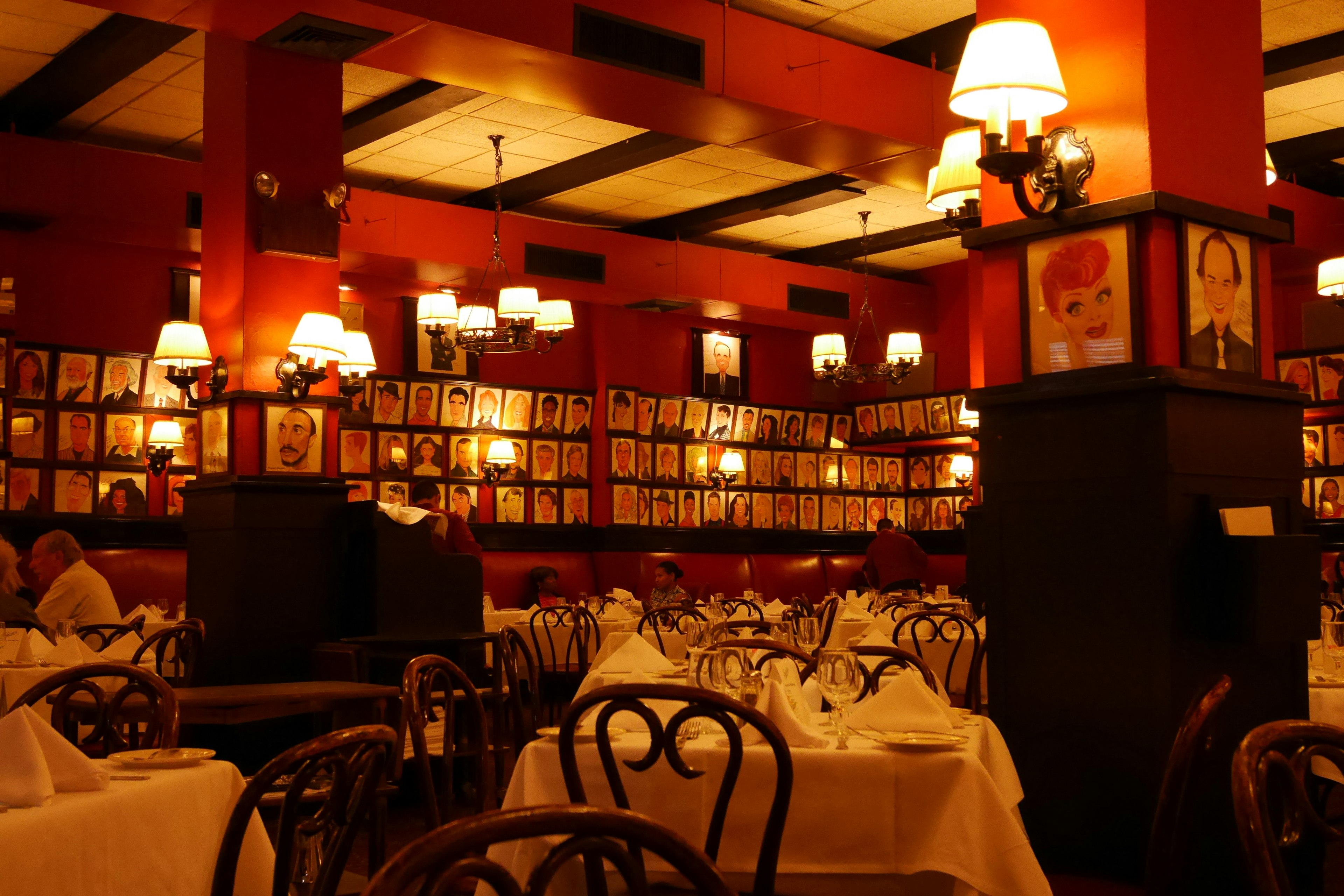 Interior of a restaurant featuring red walls and lamps