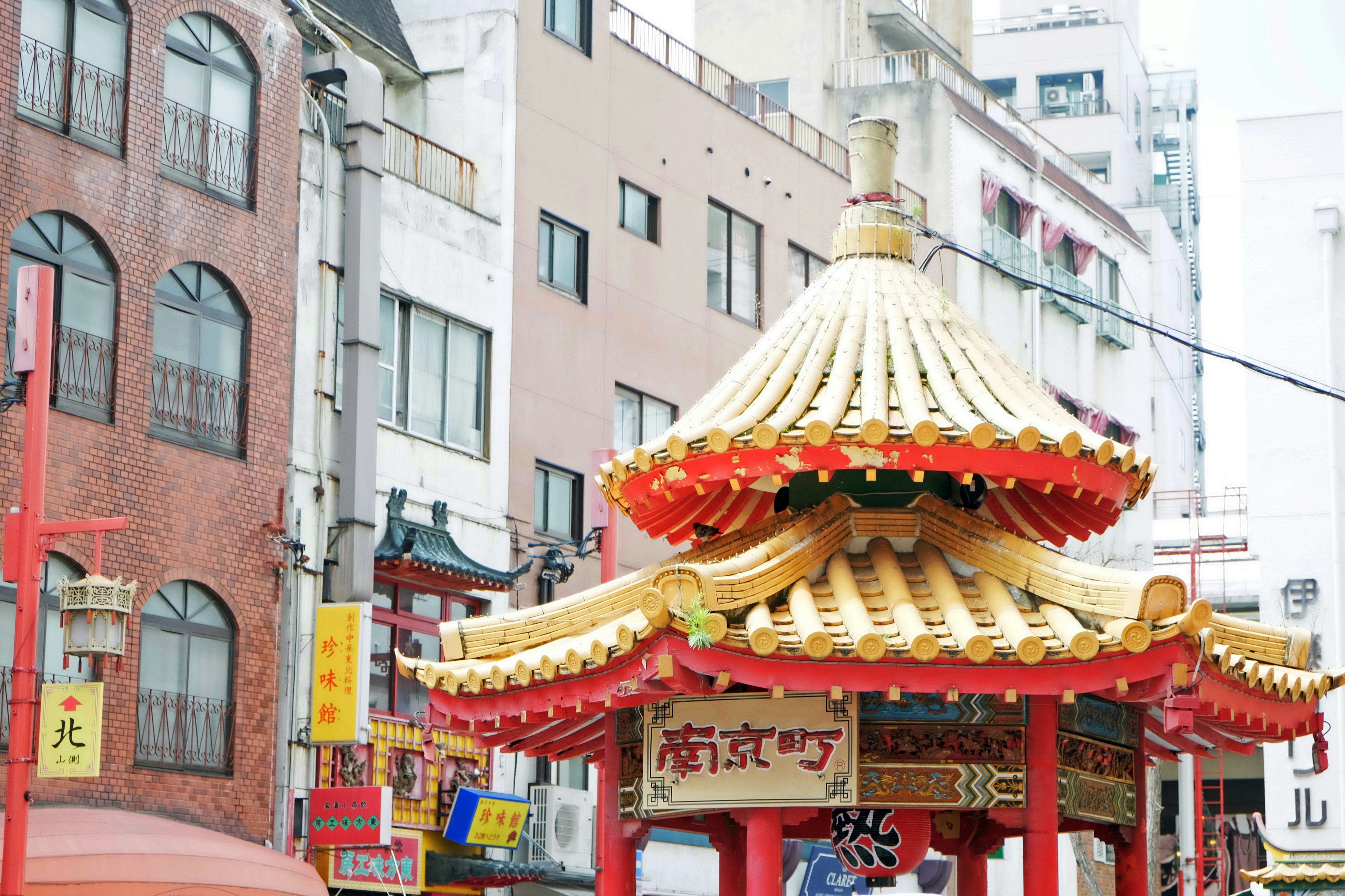 Street scene featuring a Chinese-style pavilion with a red and gold roof