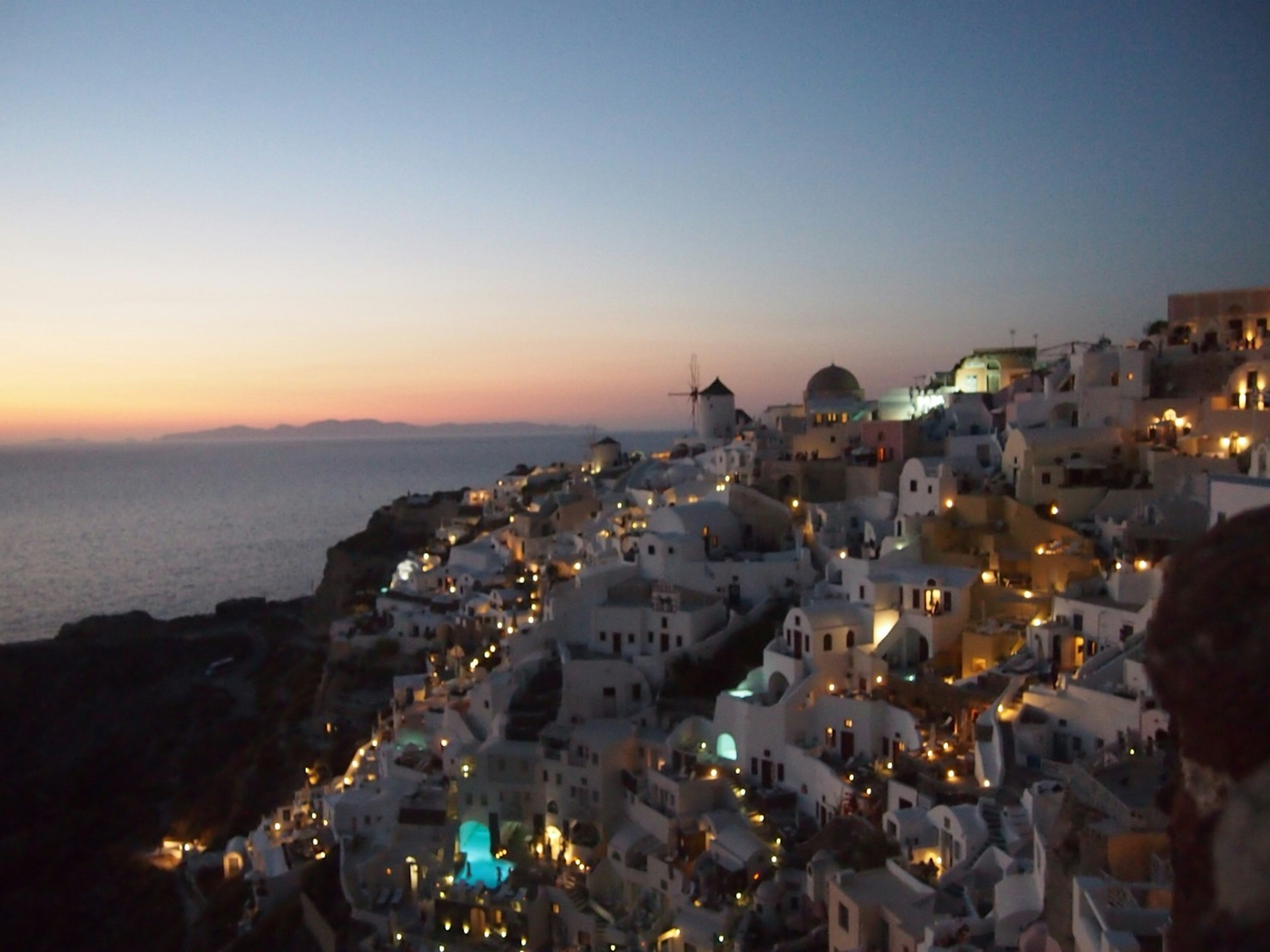 サントリーニの夜景 美しい白い建物と青い海の背景