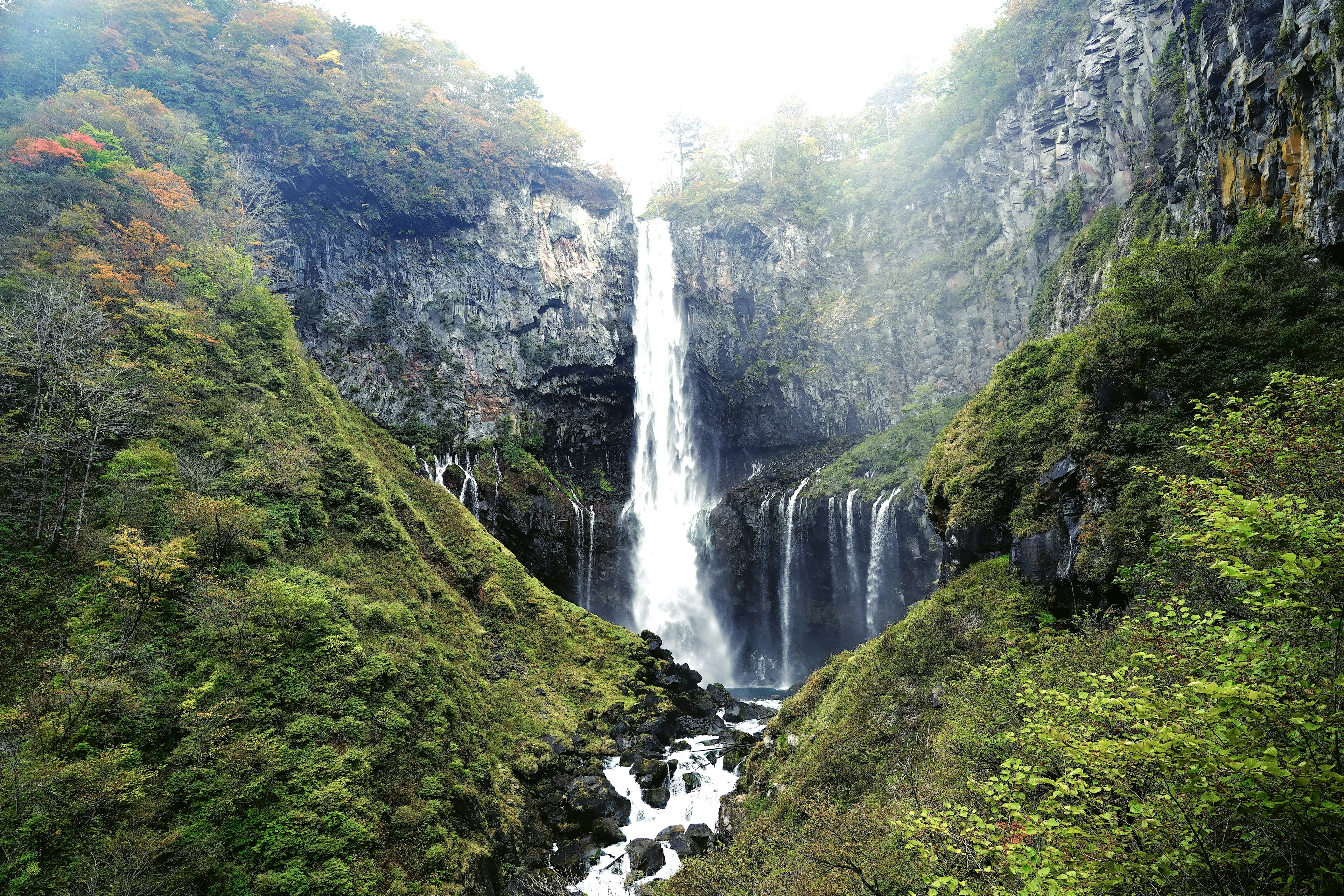 A beautiful waterfall surrounded by lush green mountains