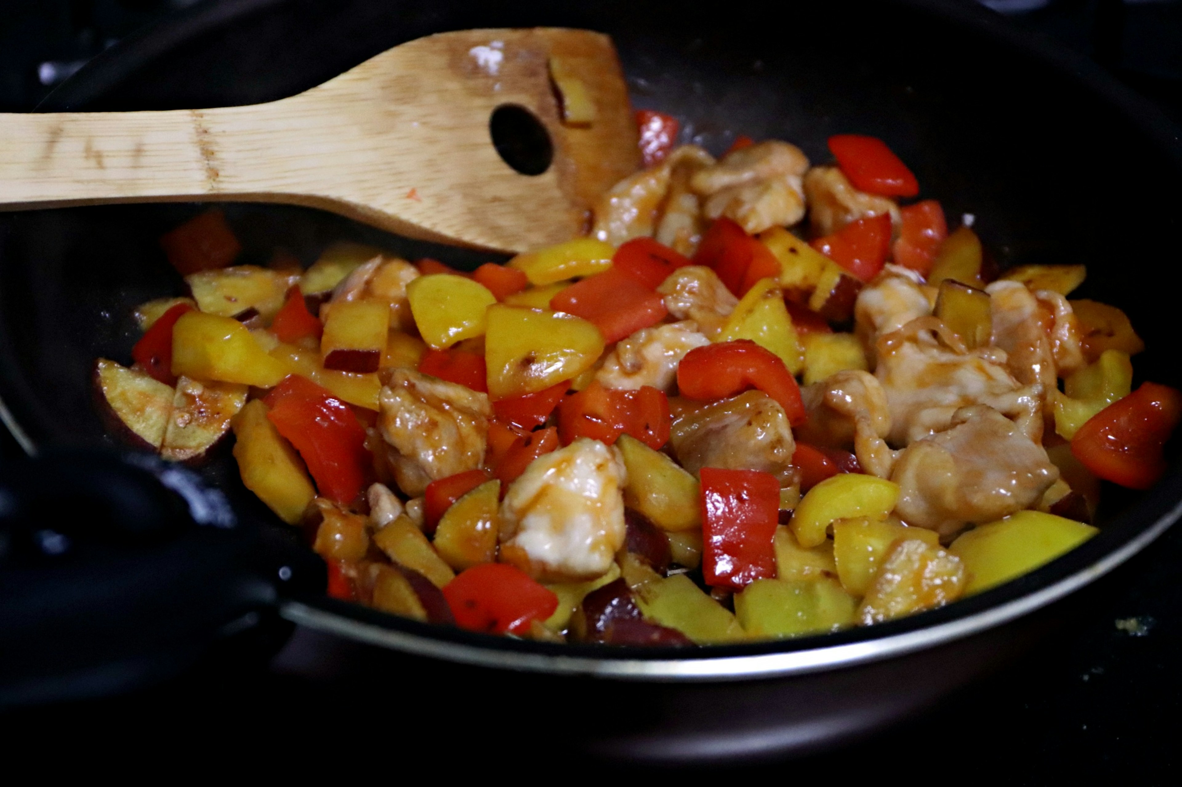 Stir-fried chicken with colorful vegetables in a pan