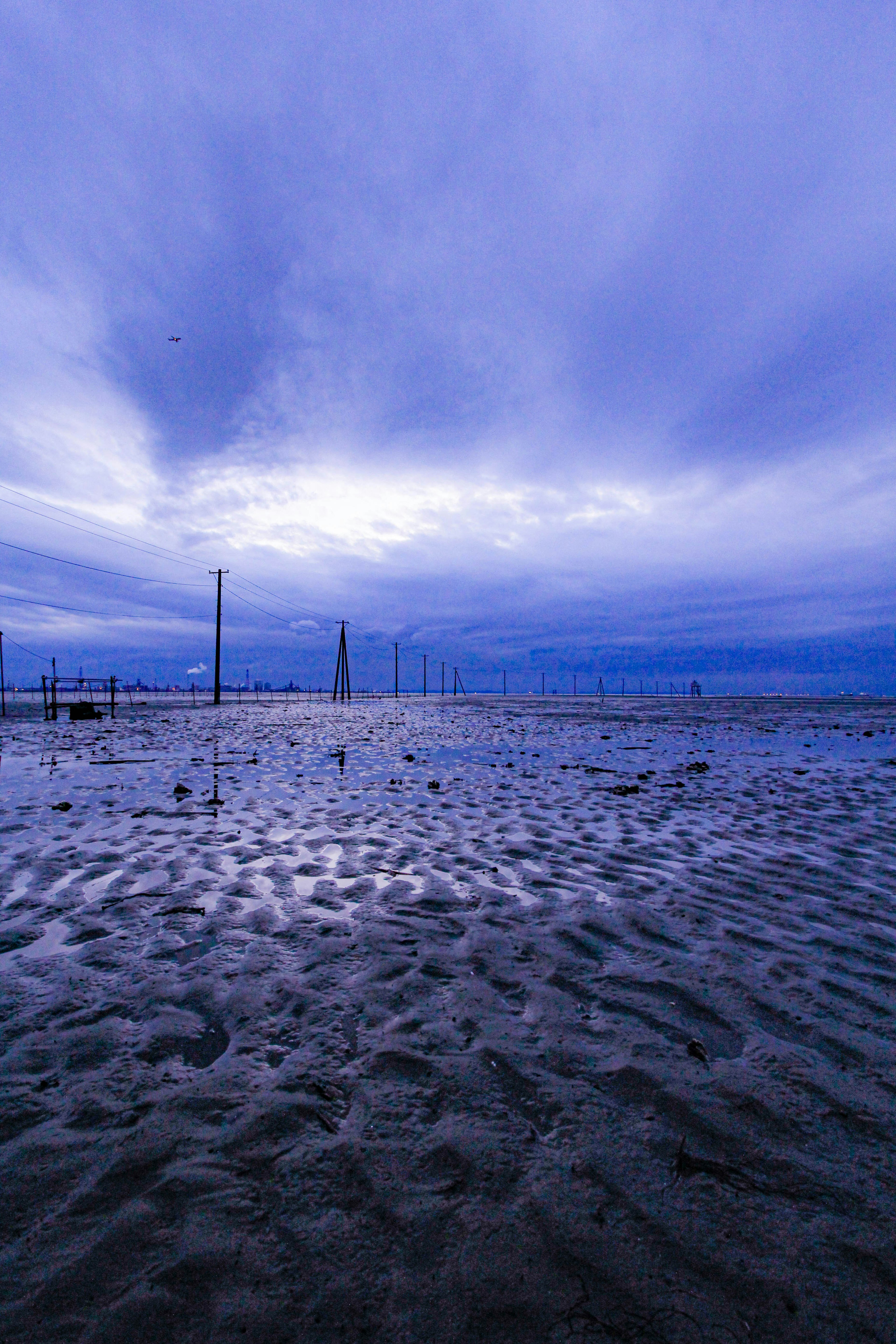 Coastal landscape with blue sky and reflective water surface