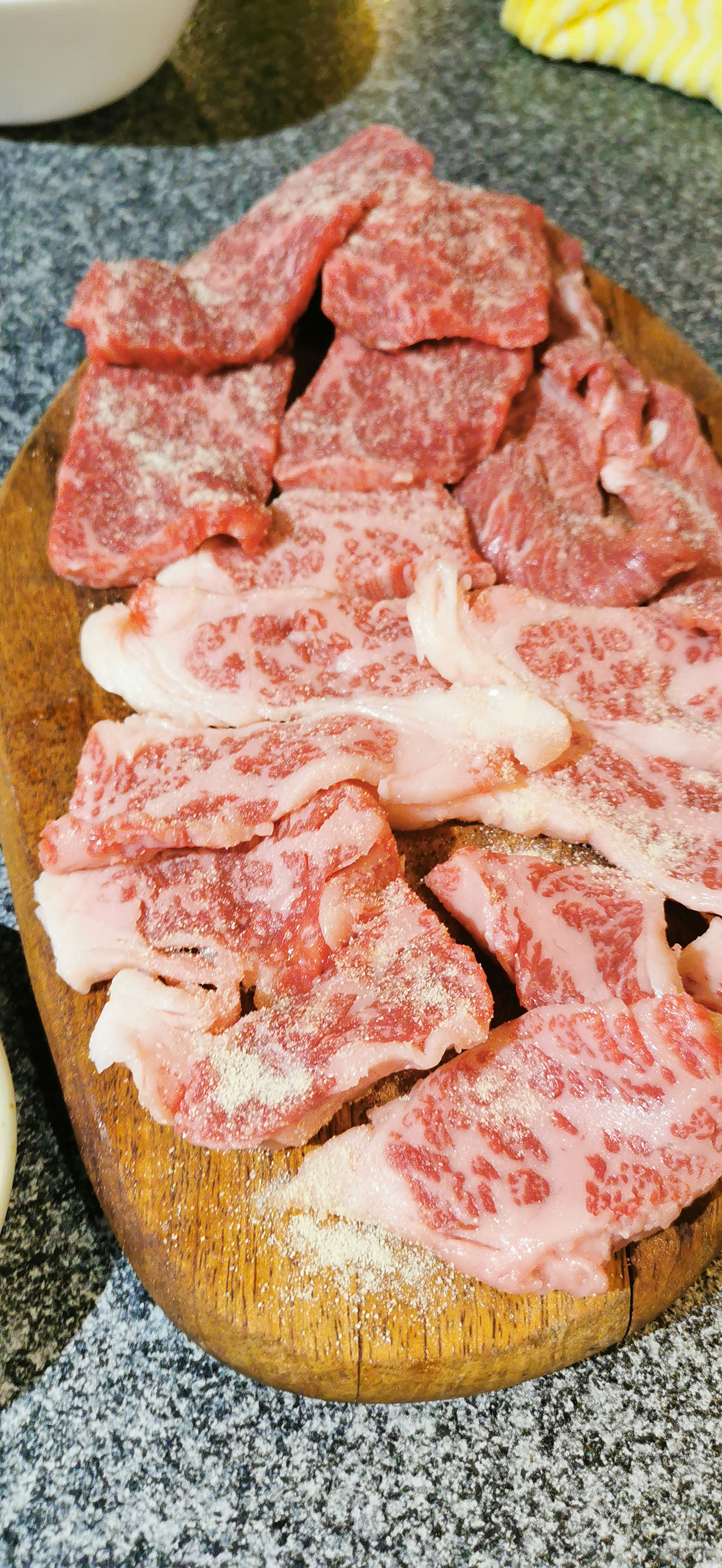 Sliced Wagyu beef displayed on a wooden board