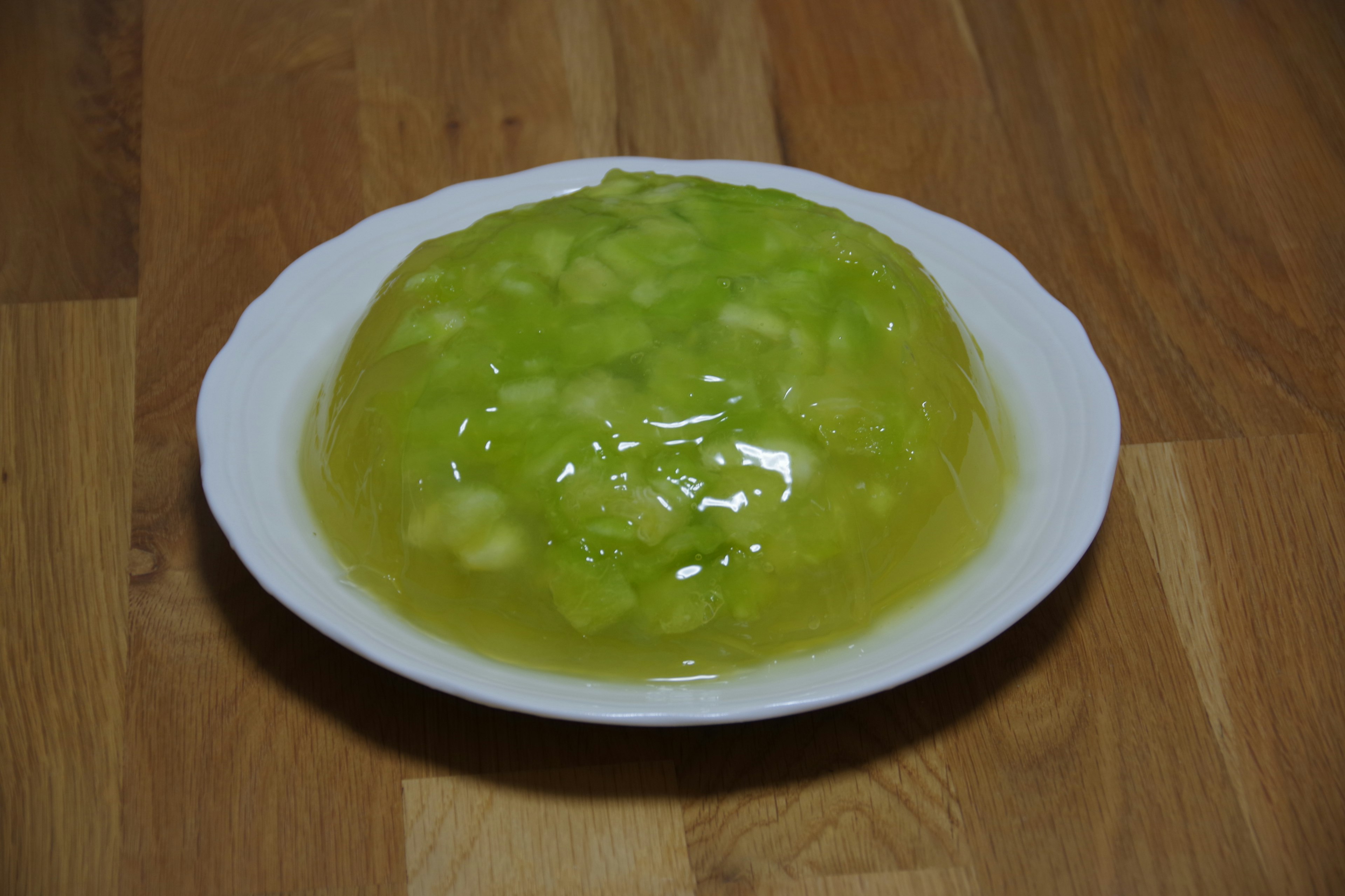 Green gelatin dessert on a white plate