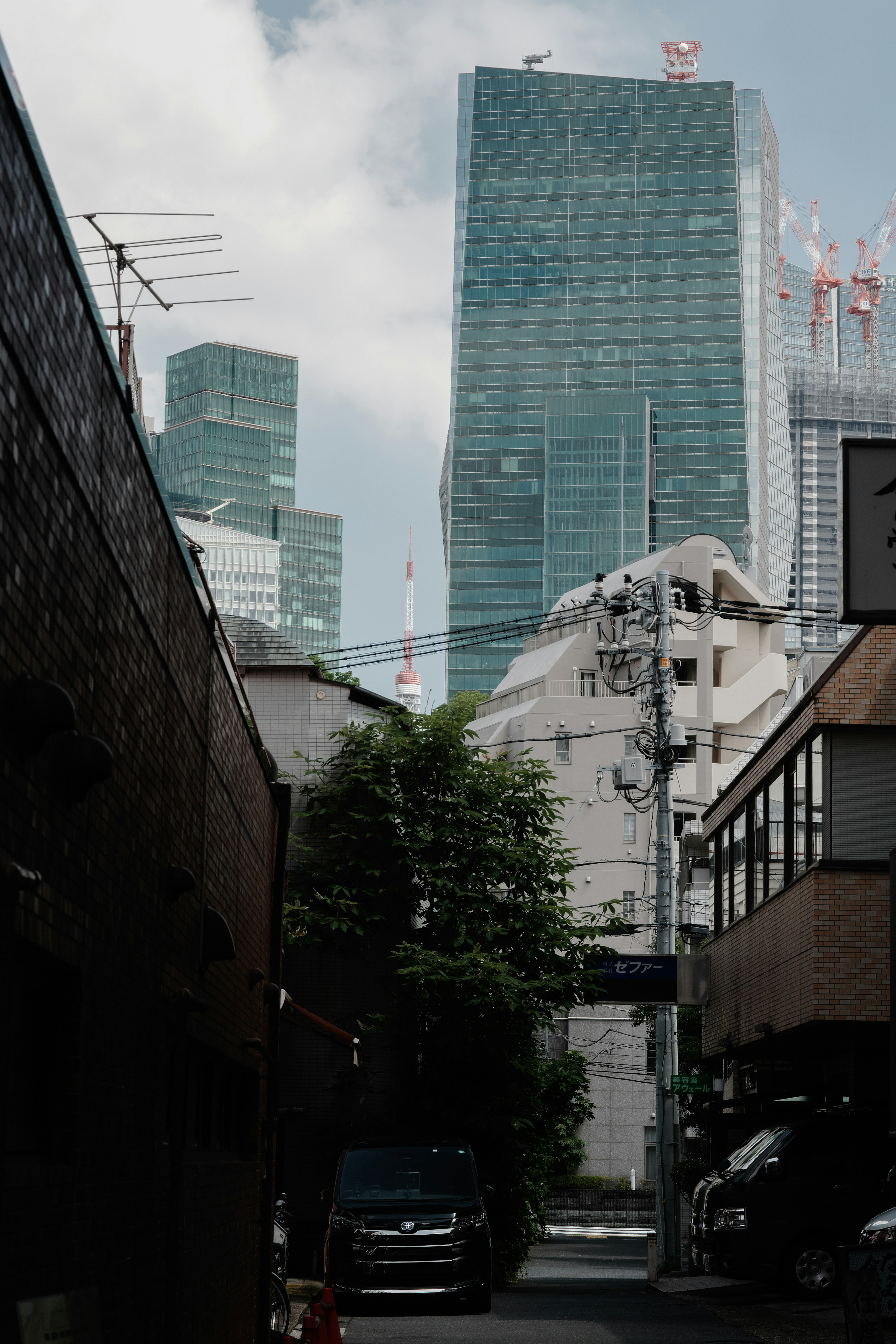 Urban scene featuring tall buildings and a narrow alley