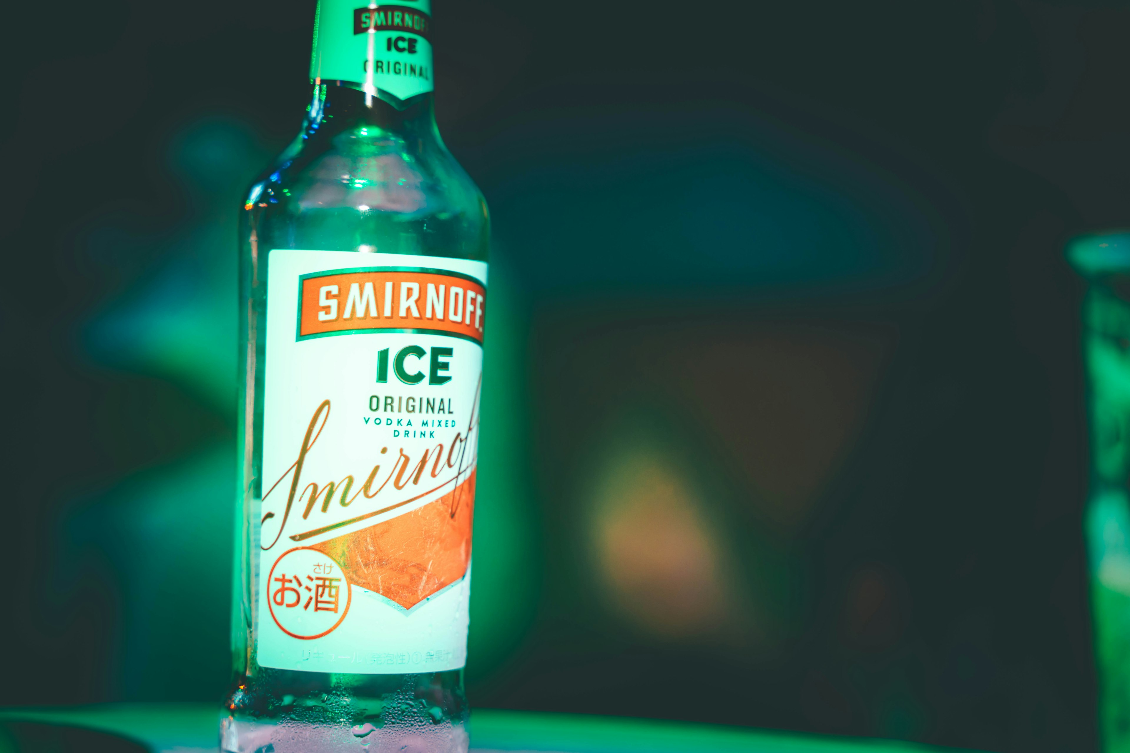 Botol Smirnoff Ice diterangi cahaya hijau