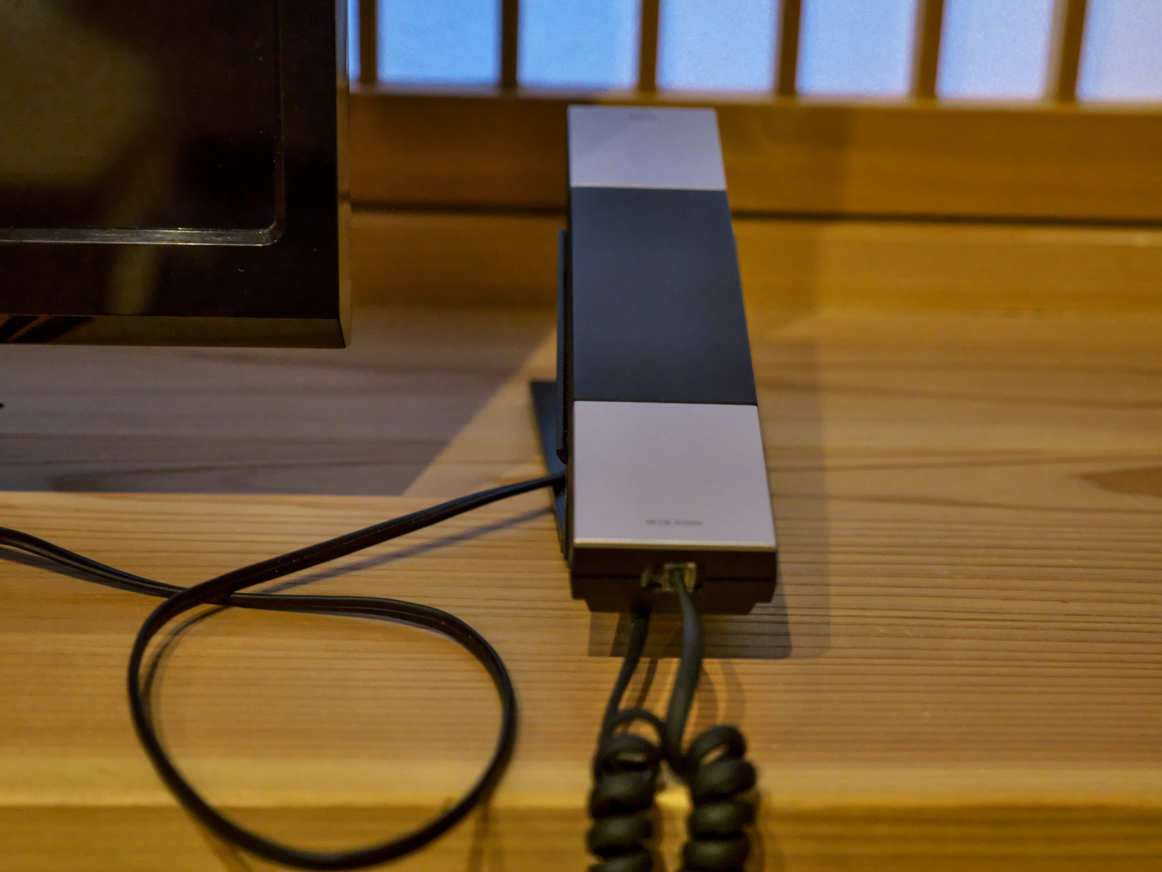 Modern designed telephone placed on a wooden table