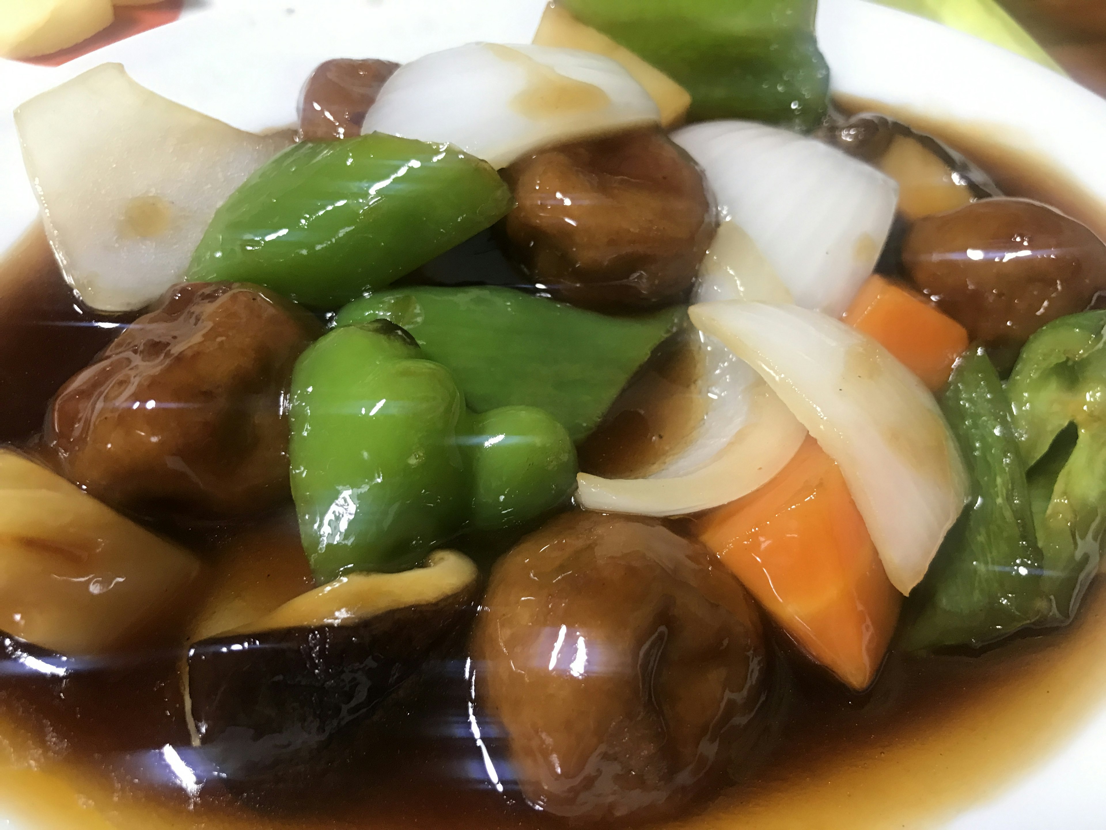 A plate of colorful stir-fried vegetables and mushrooms