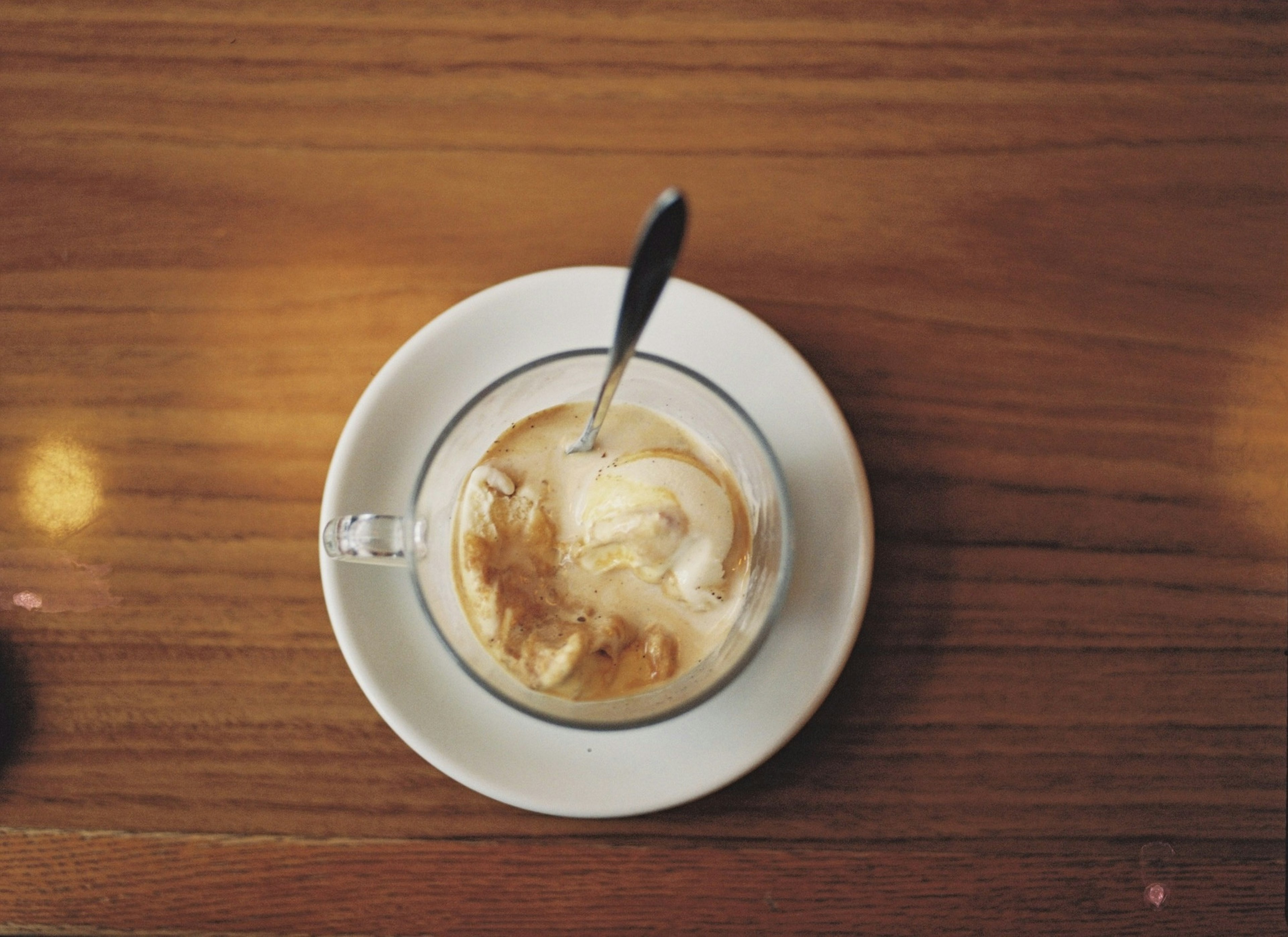 Draufsicht auf eine transparente Tasse mit Kaffee und Eis