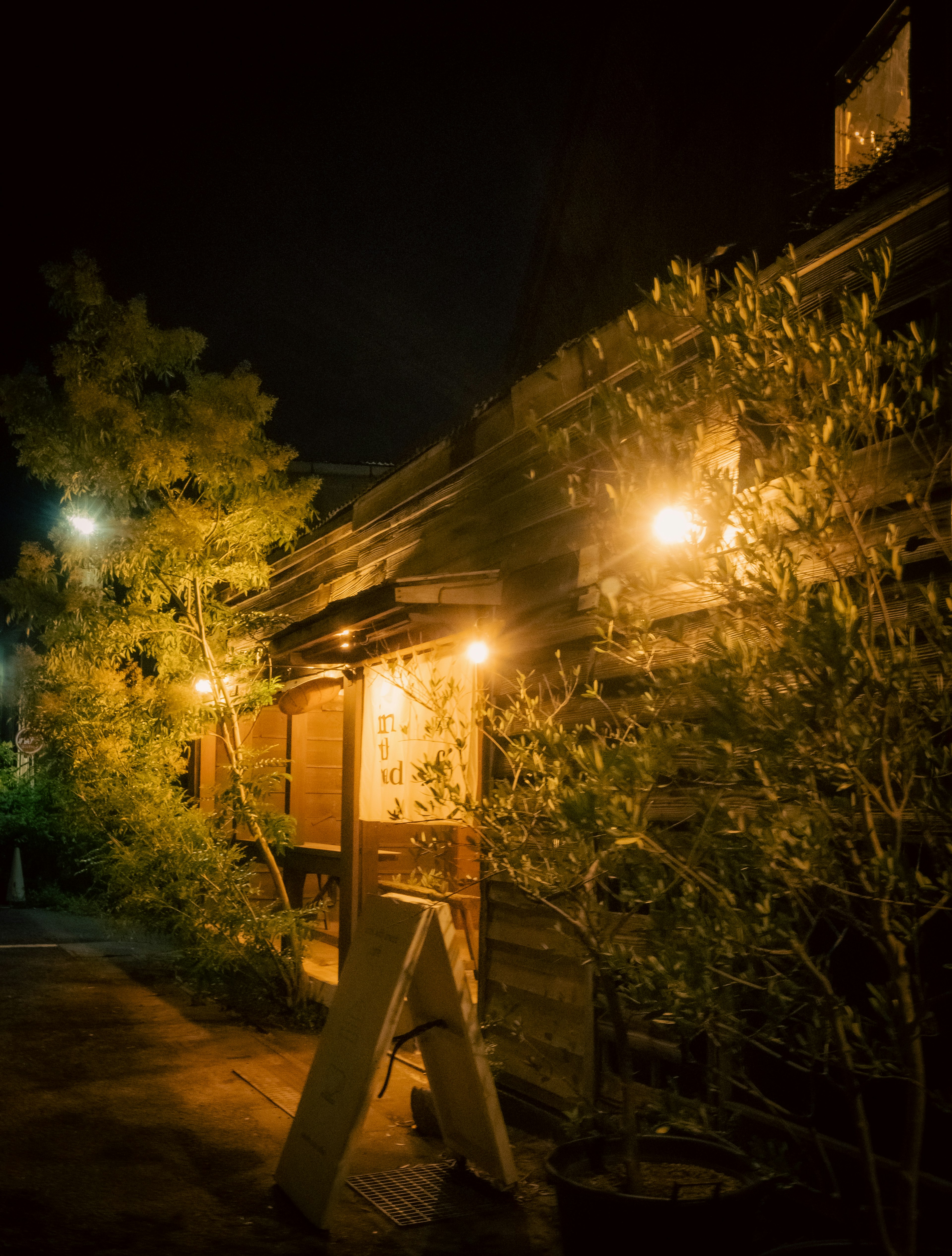 Charming restaurant exterior at night with warm lights