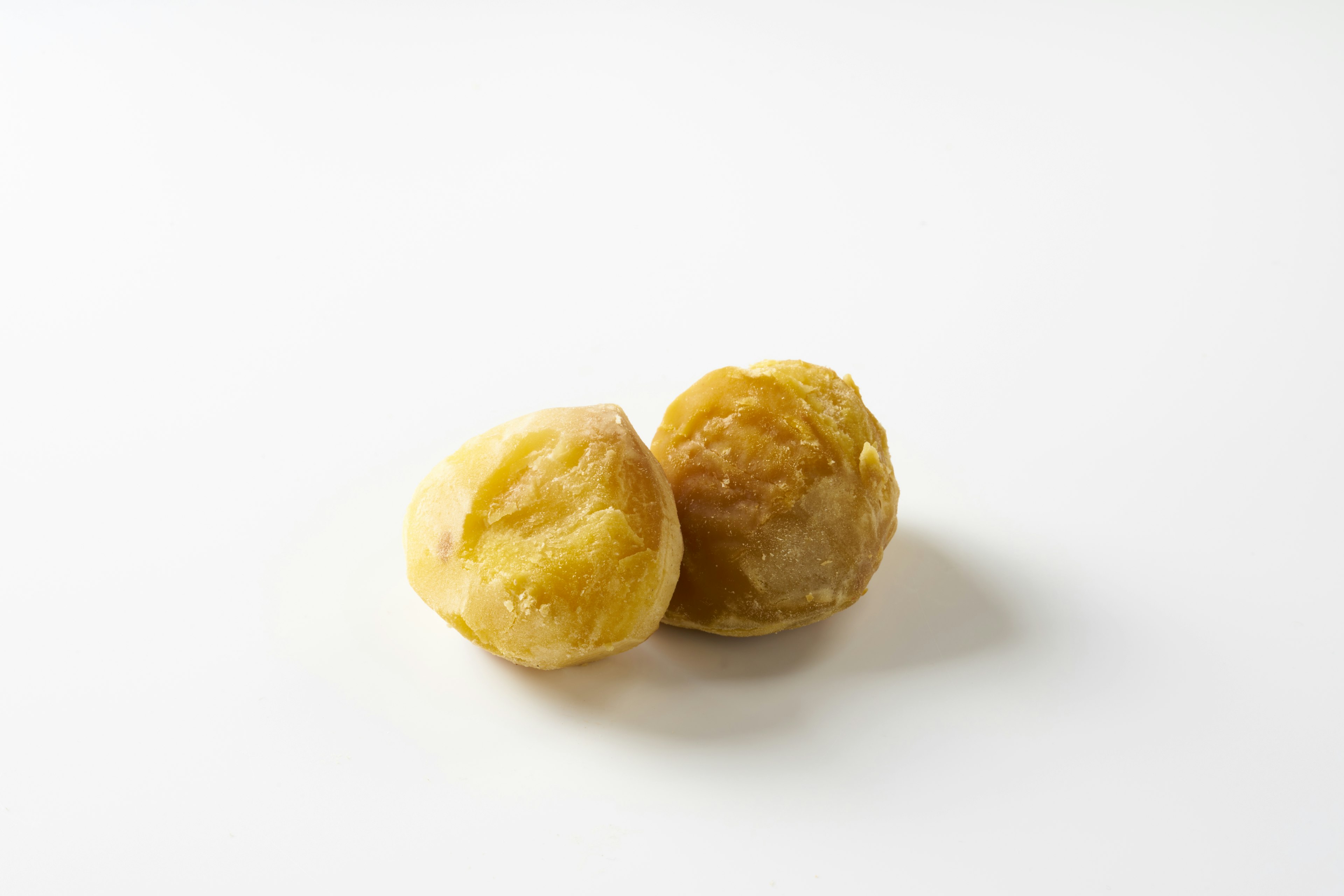 Two dried persimmons on a white background