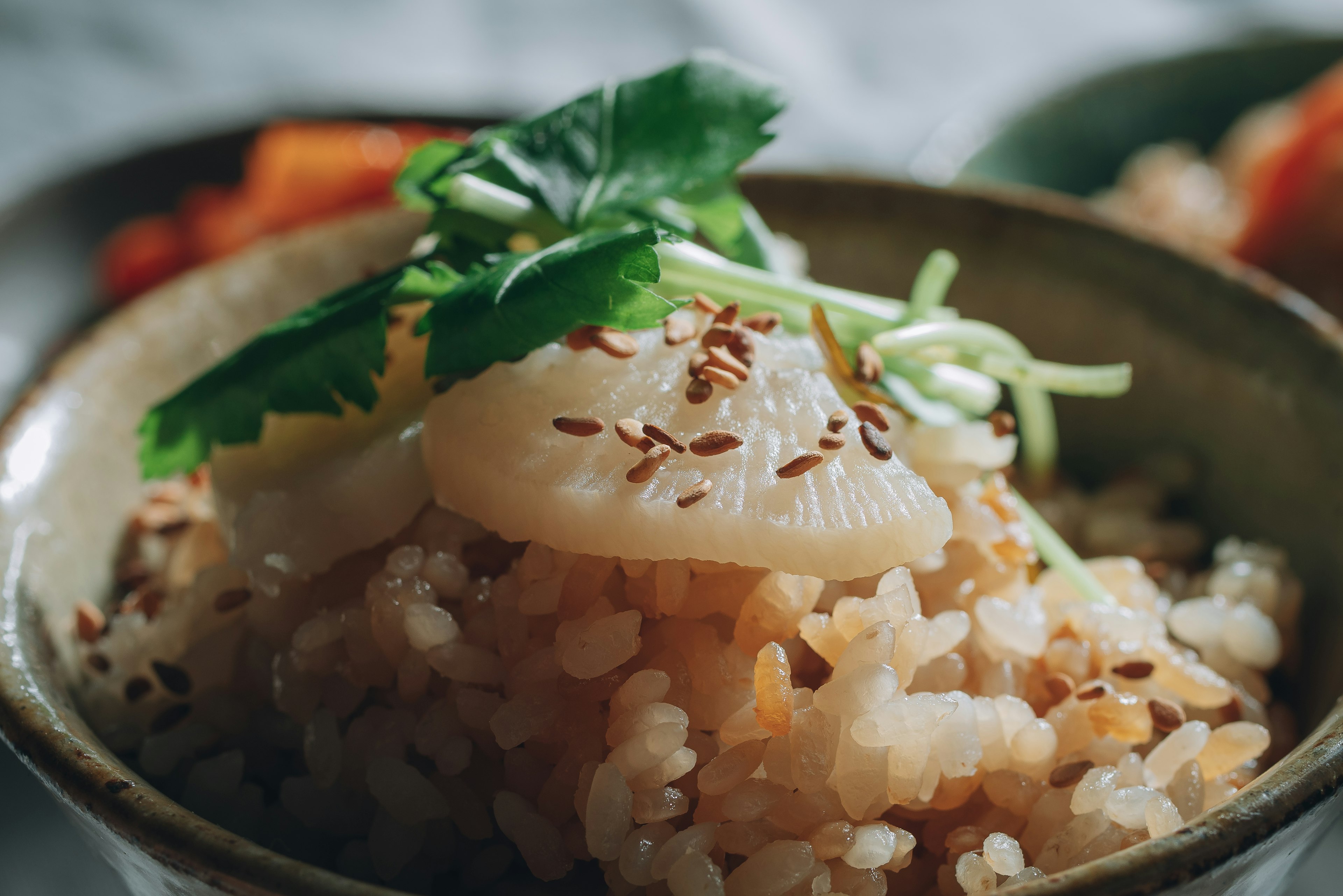 Bowl of rice topped with herbs and seeds