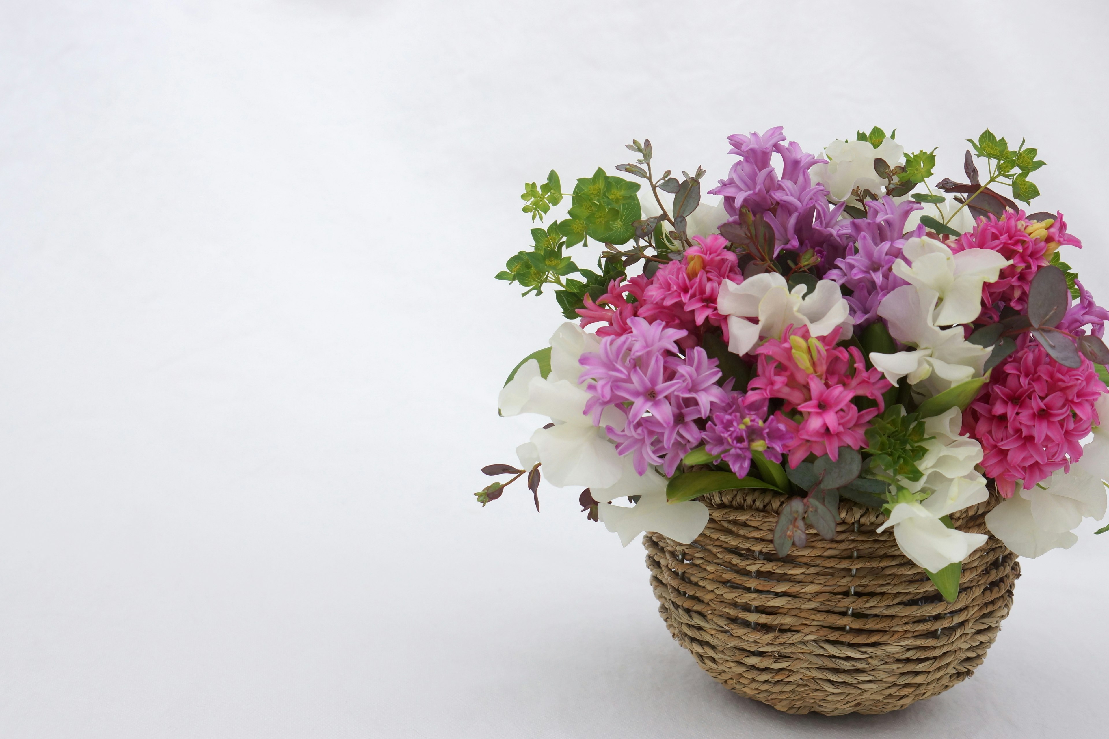 Colorful floral arrangement in a woven basket