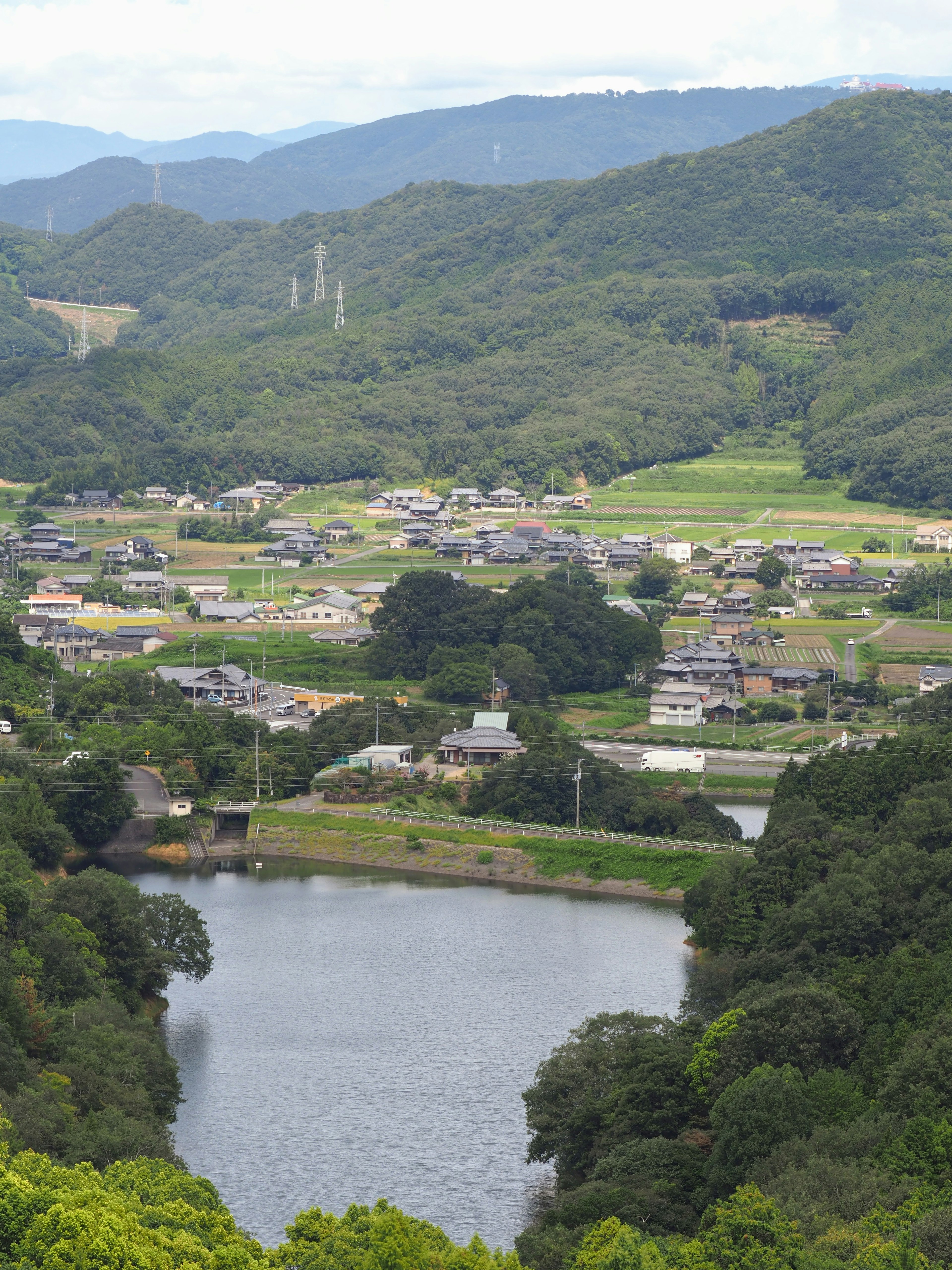 被群山环绕的宁静村庄和湖泊的景色