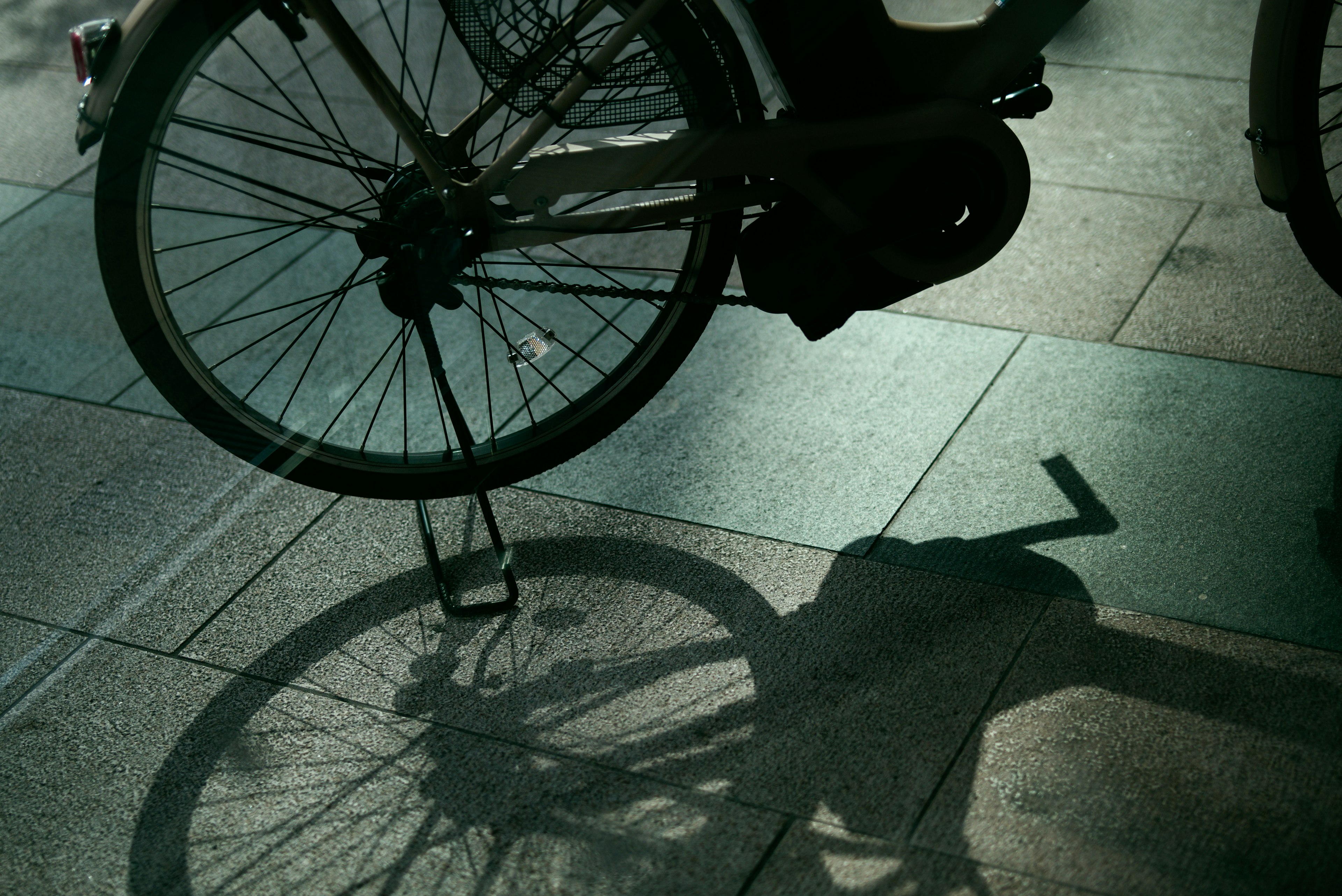 Shadow of a bicycle on the pavement