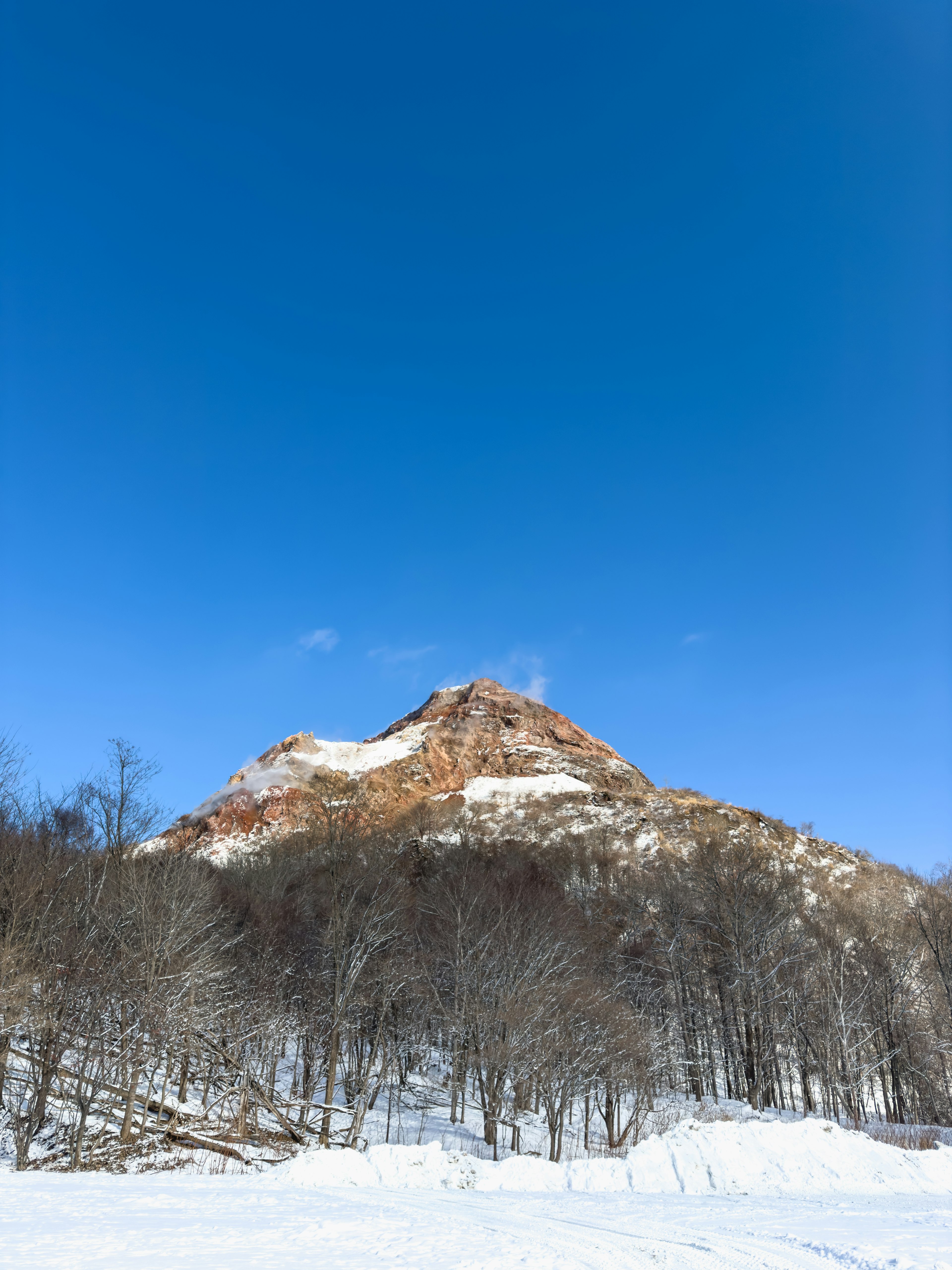 Snow-covered mountain with clear blue sky