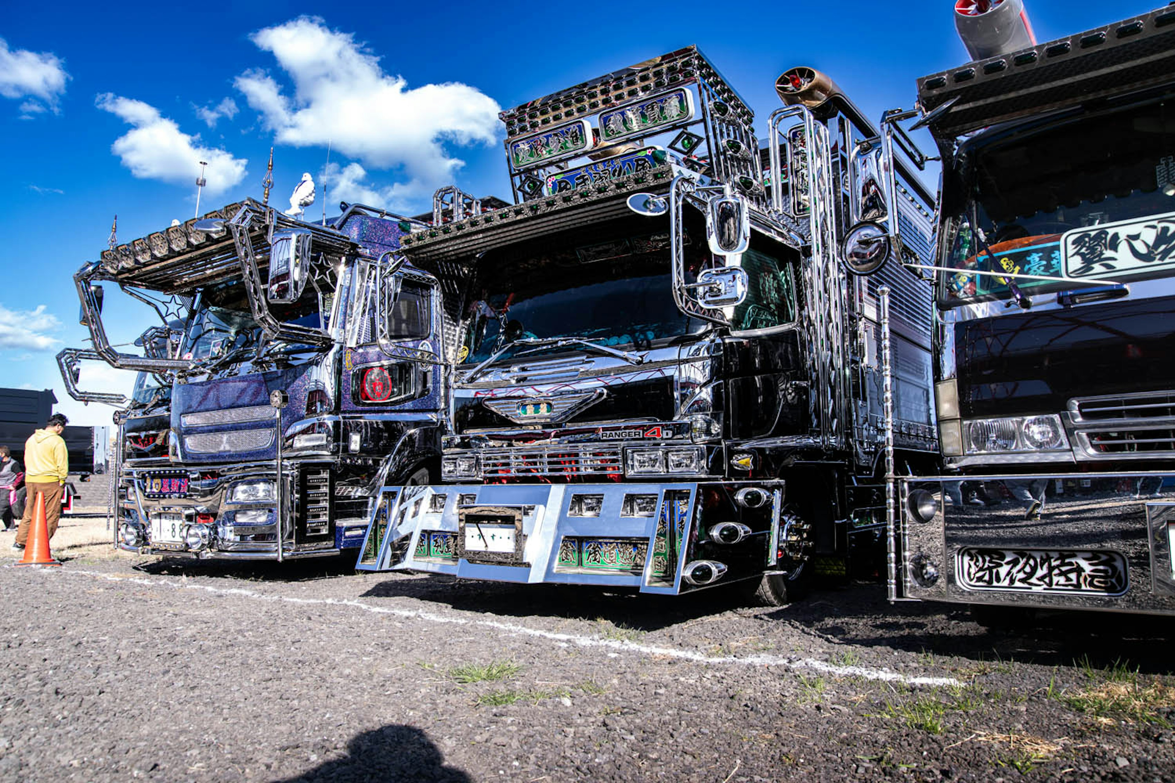 Row of custom trucks with chrome finishes and unique designs