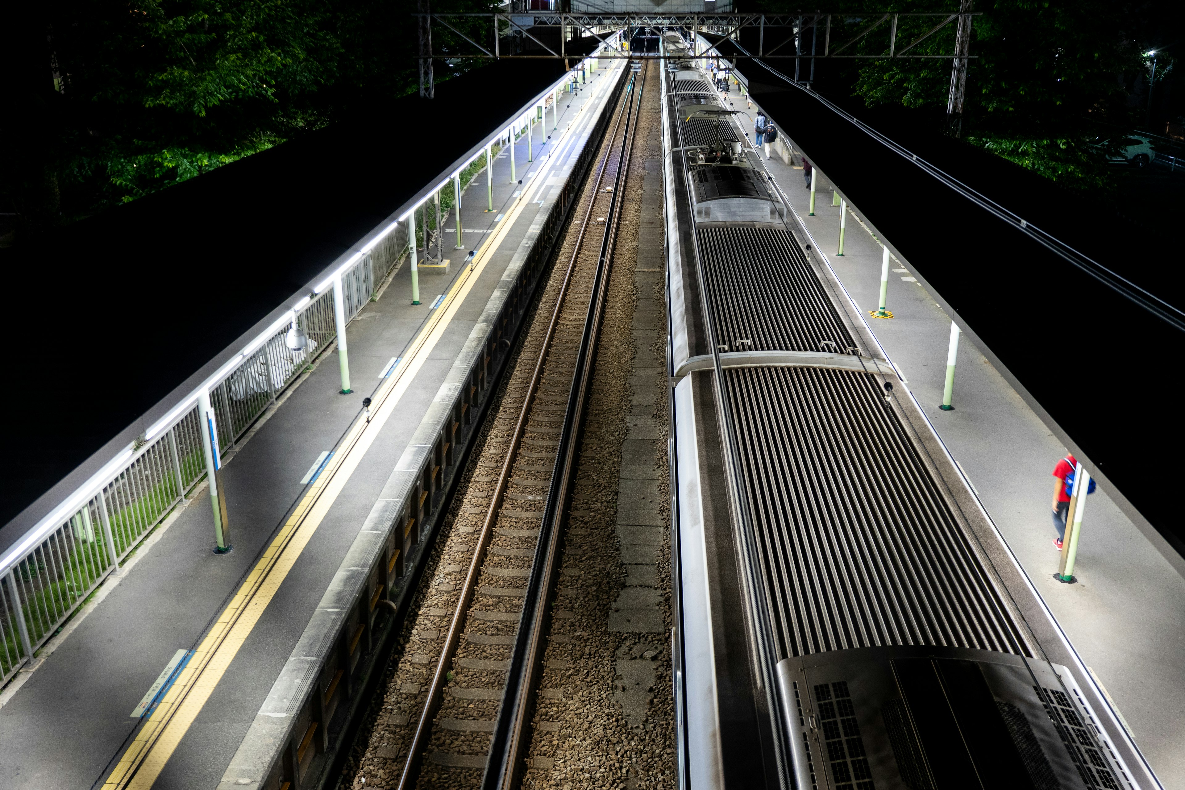 Night view of train station platforms and tracks