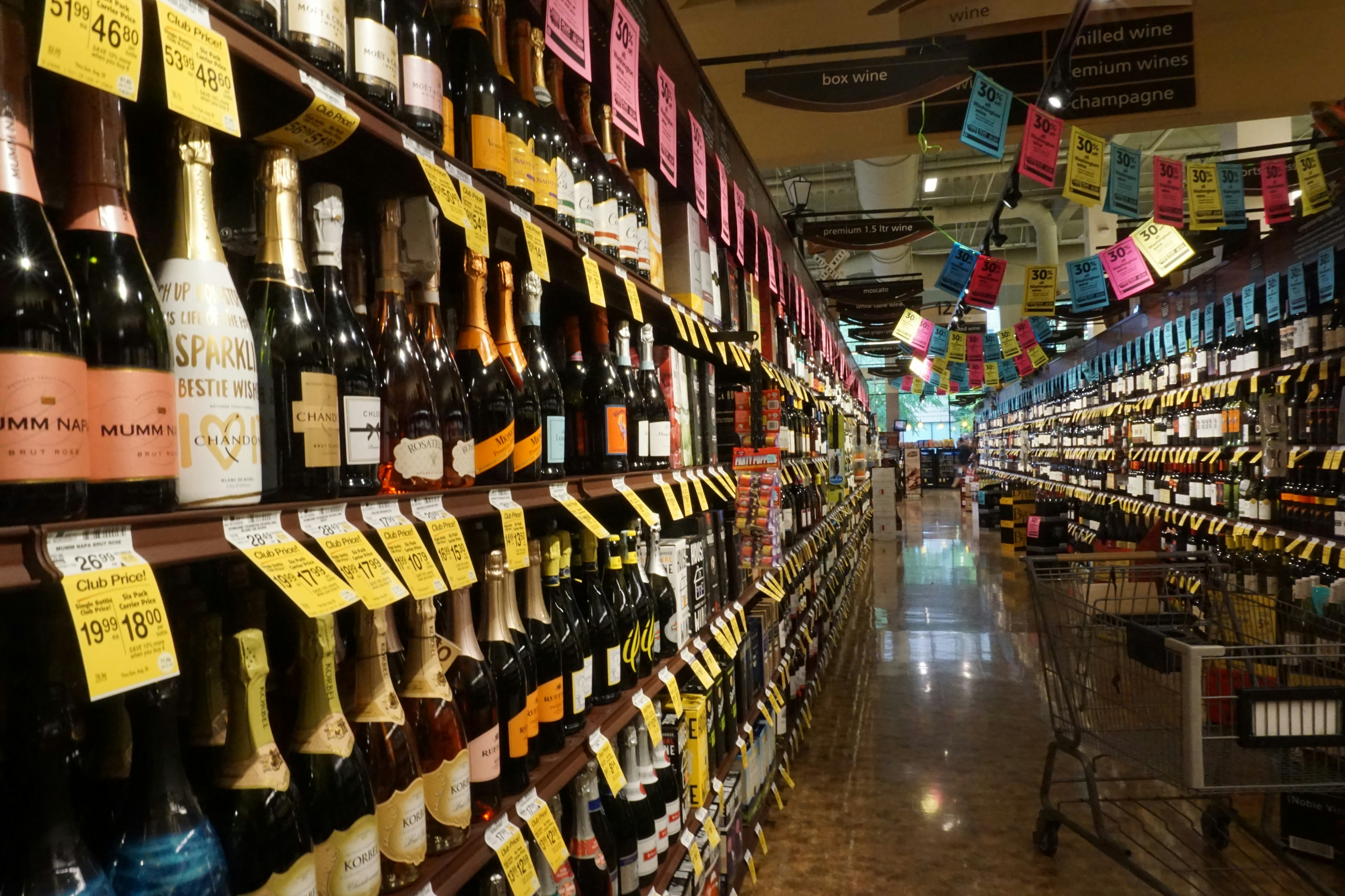 A grocery aisle filled with various wines and sparkling wines on shelves