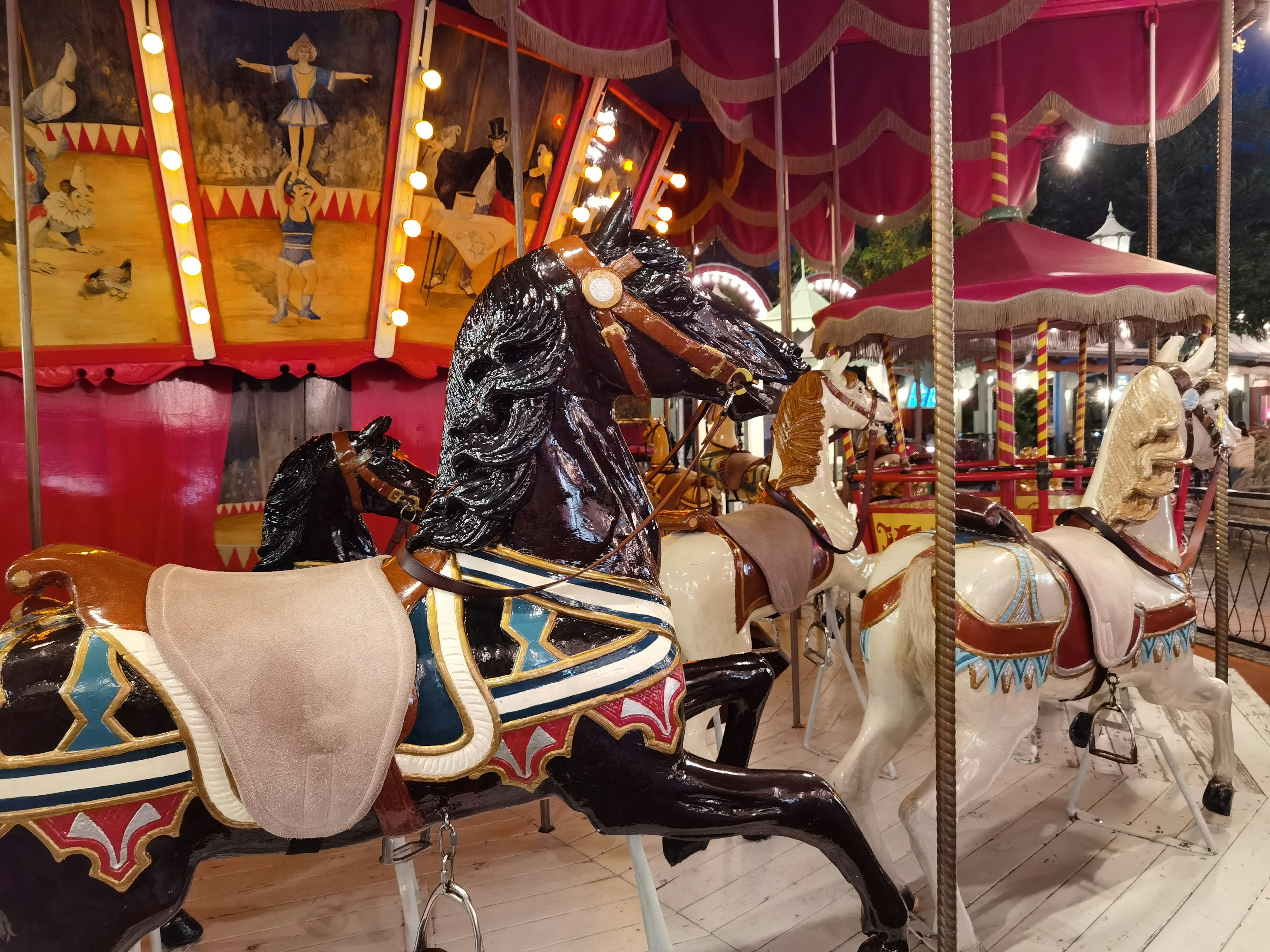 Carousel horses with vibrant colors at night