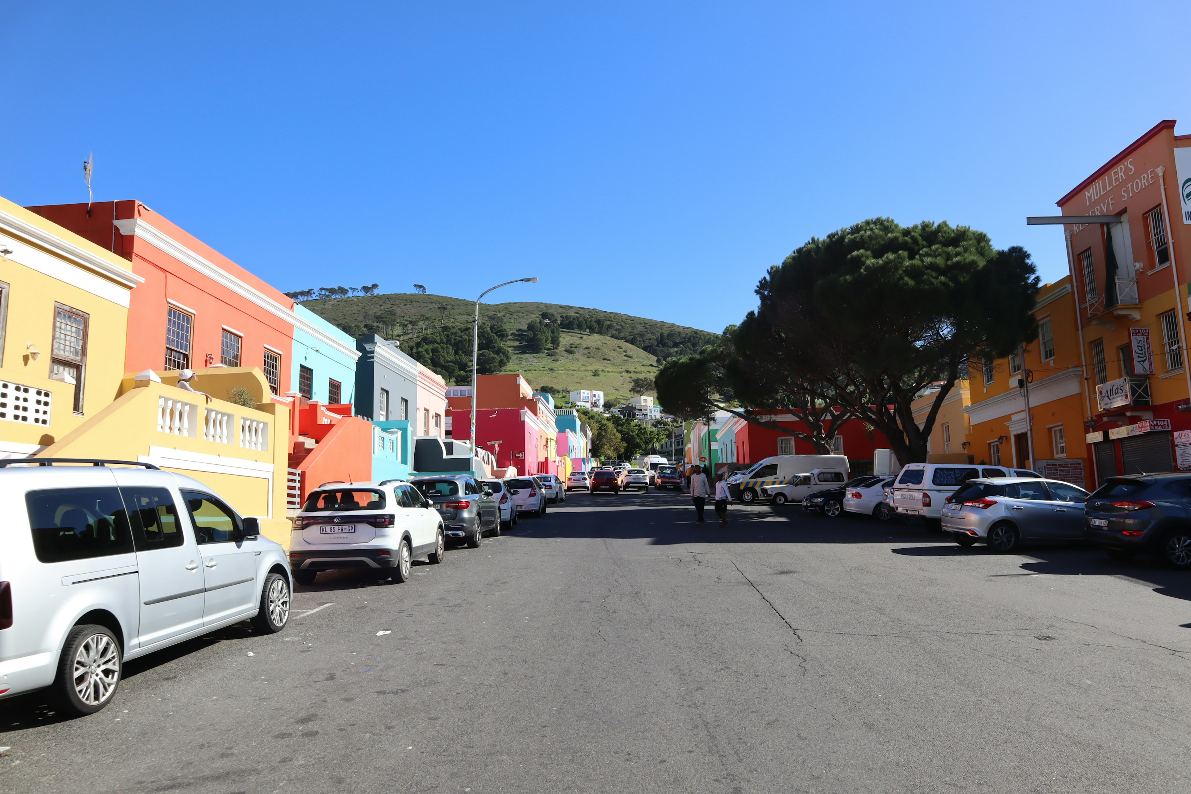 Colorful houses lining a street under a clear blue sky