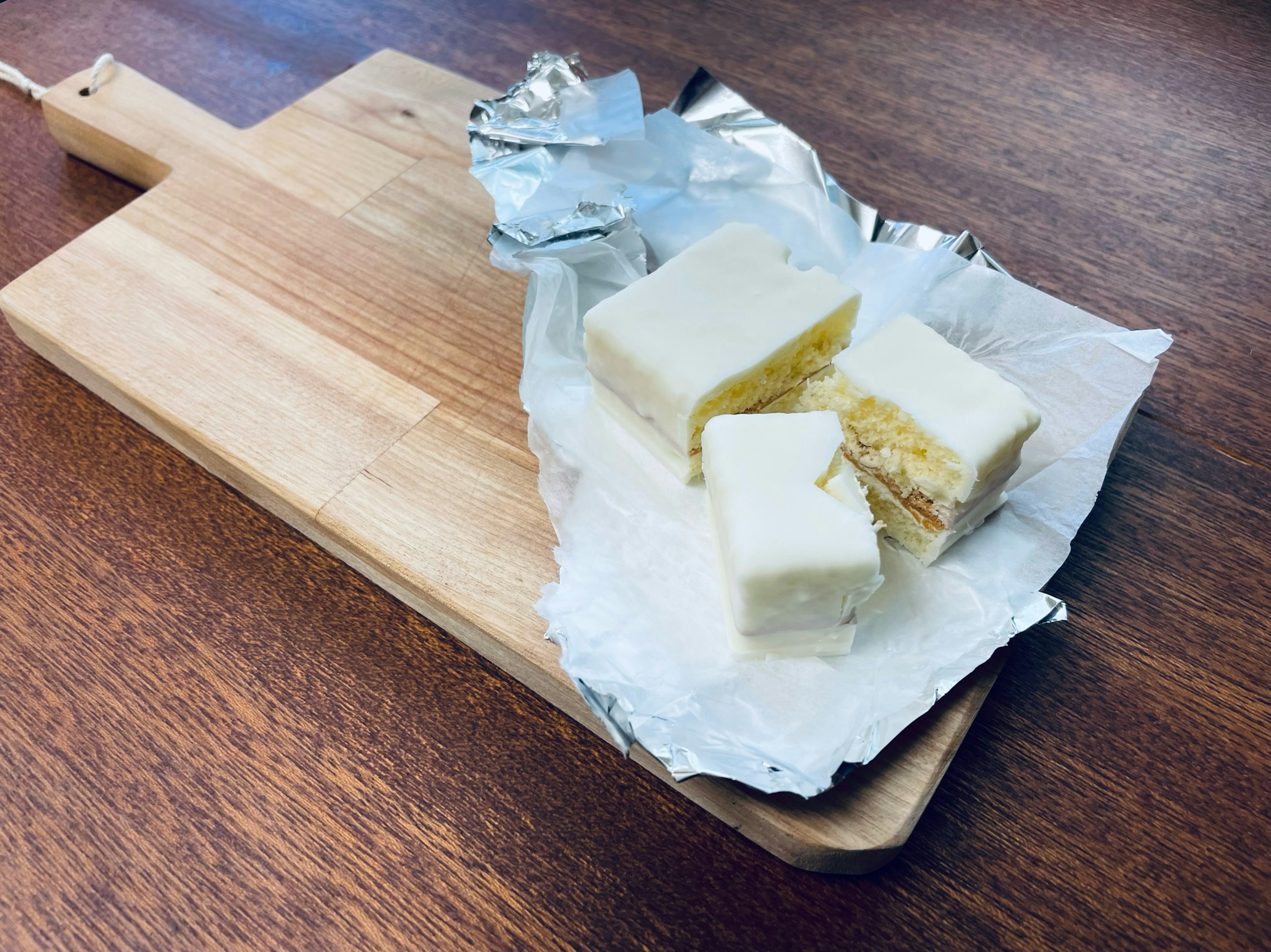 Creamy white confection pieces on a wooden cutting board