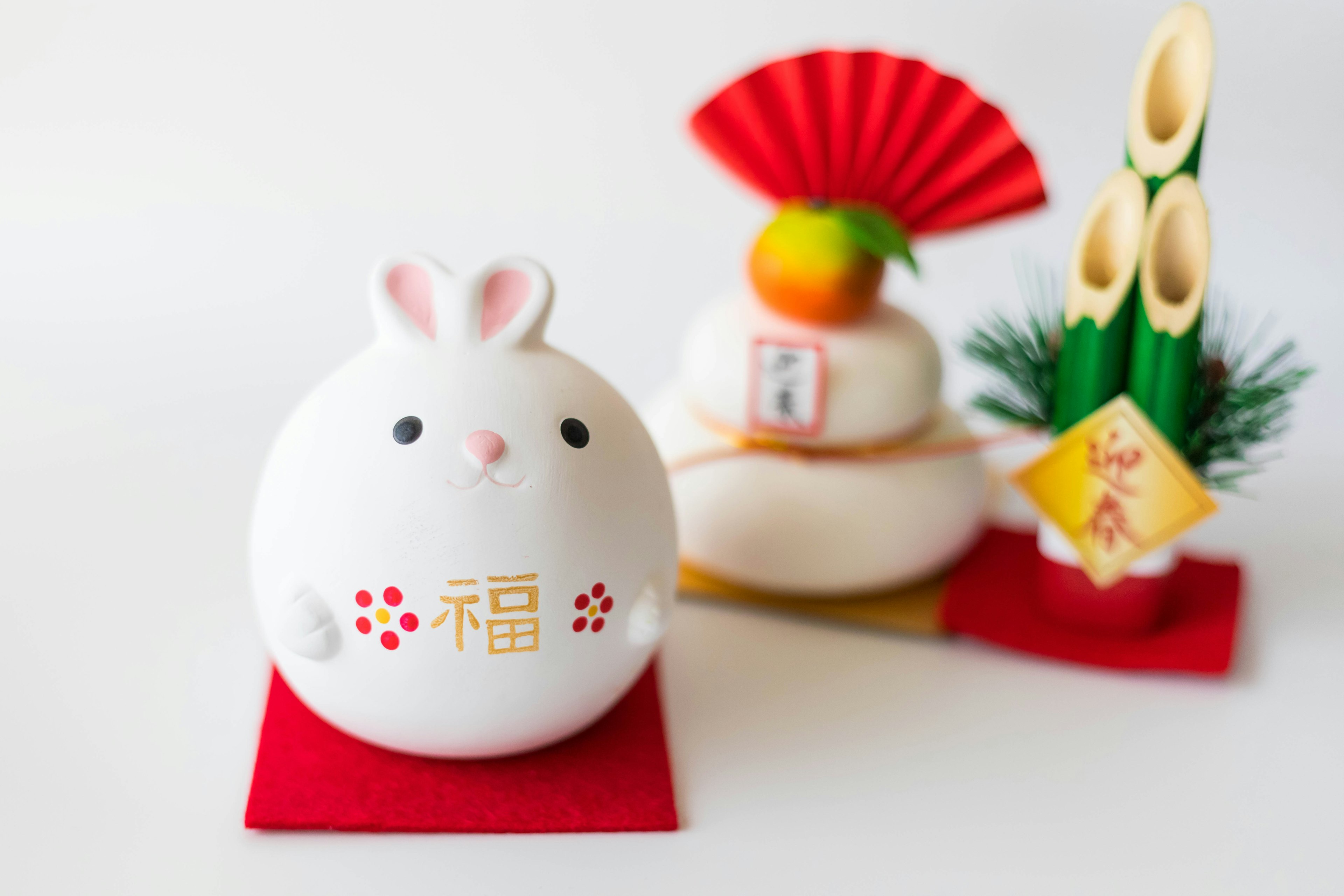 A white rabbit figurine alongside traditional New Year decorations