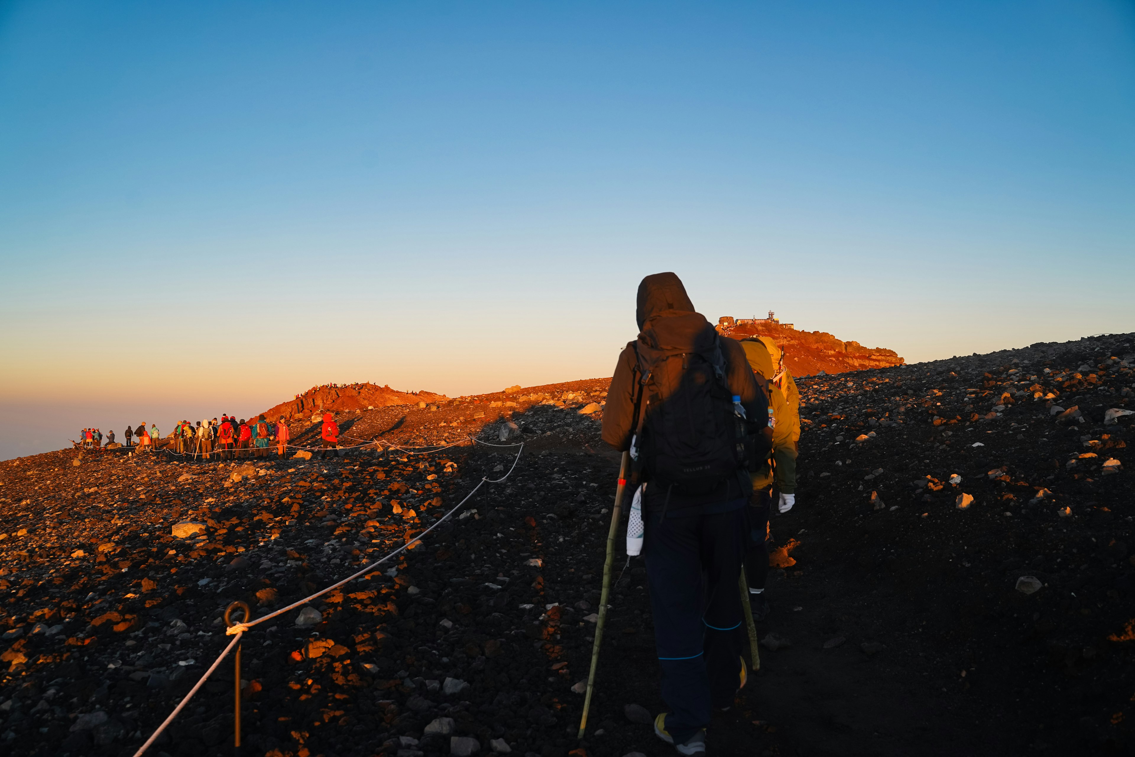 Senderistas en un sendero con un cielo al atardecer