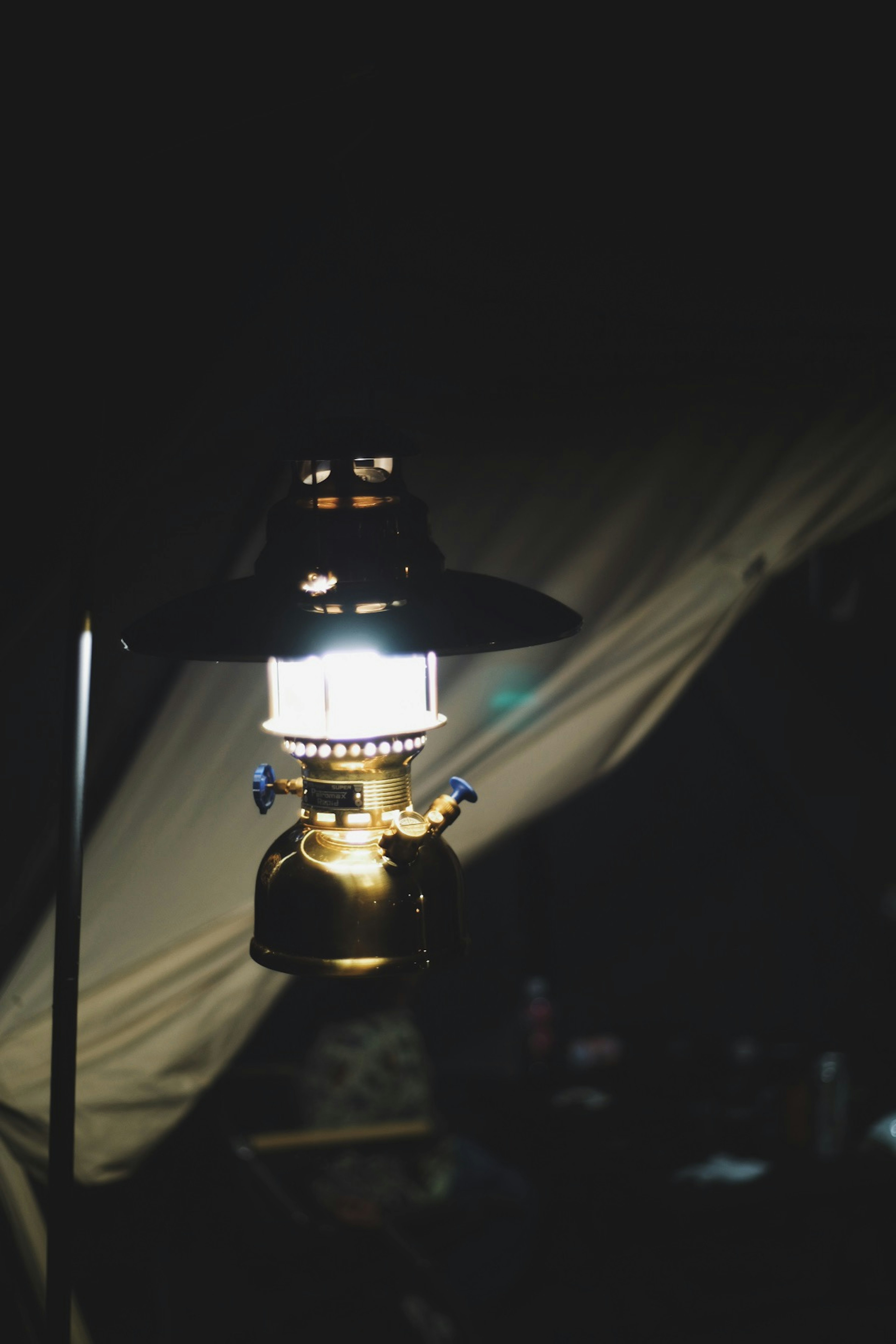 A camping lantern illuminating a dark background