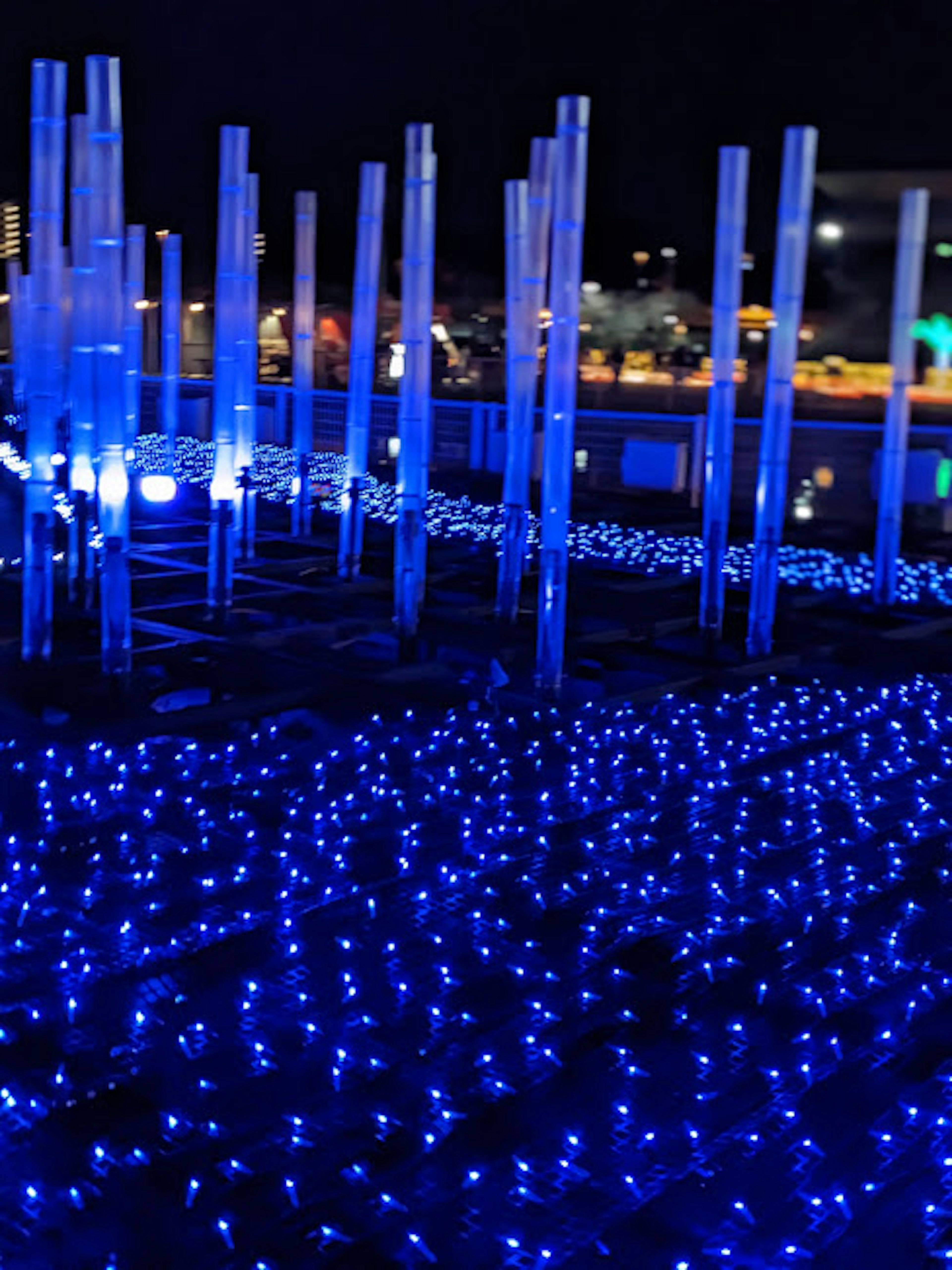 Blue illuminated columns and glowing ground at night