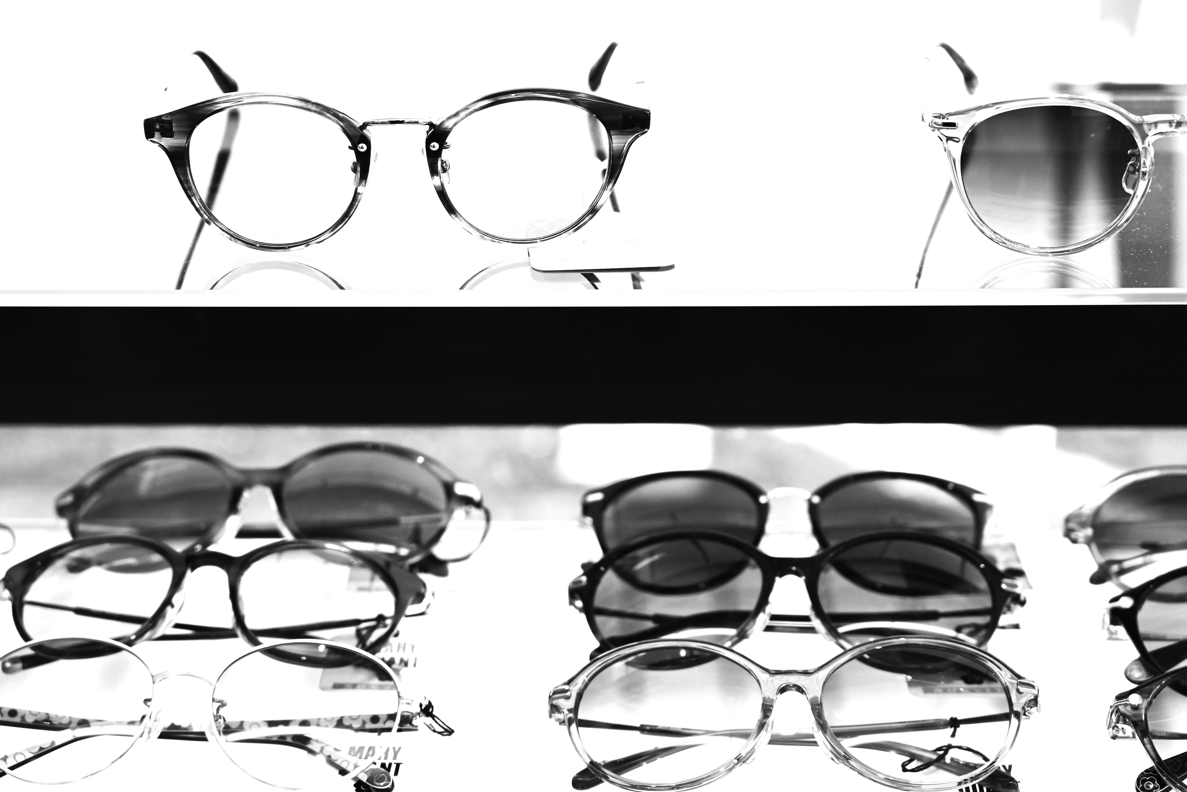 Display of various eyeglasses including sunglasses in black and white