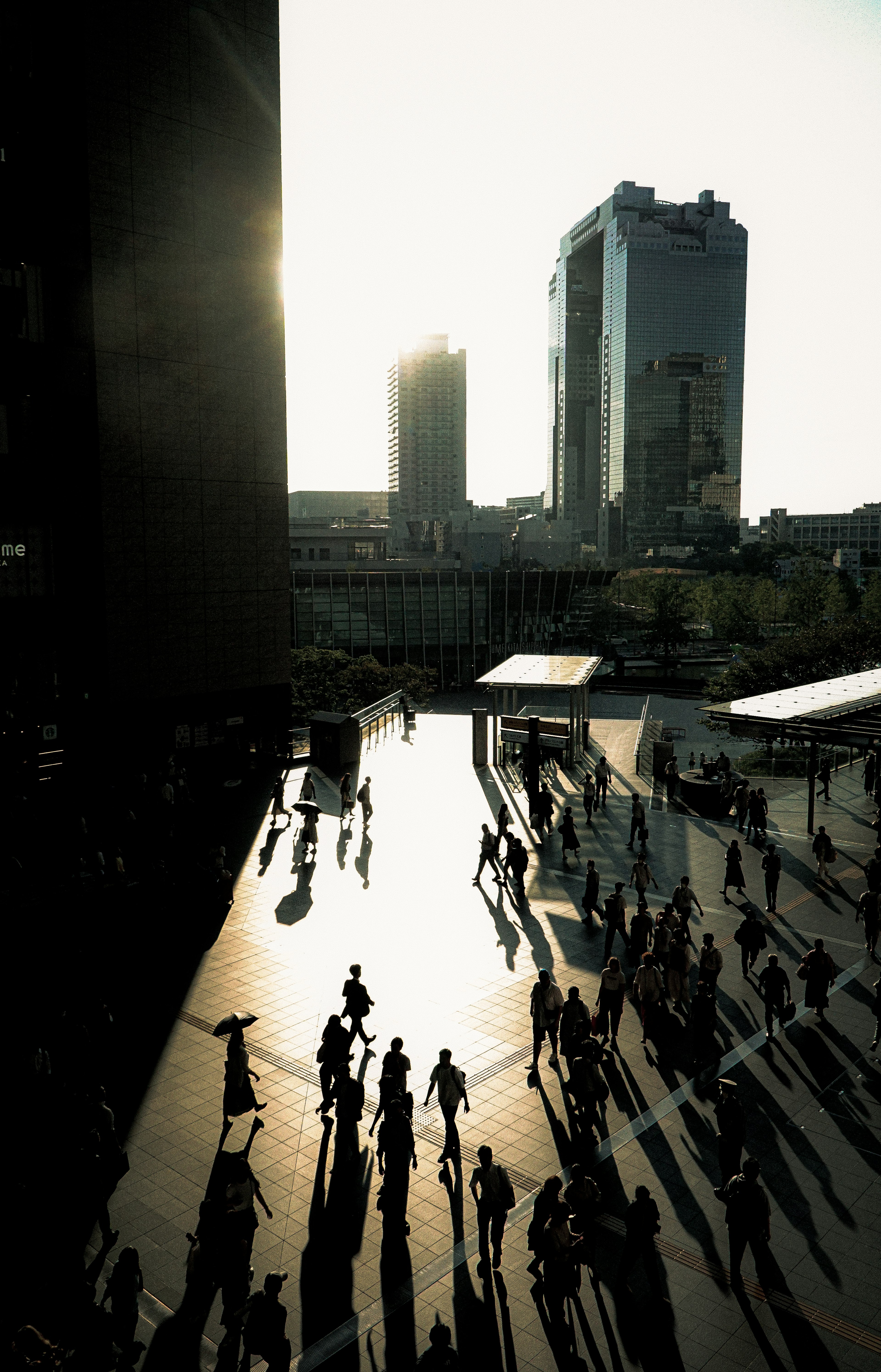 Urban landscape with people silhouetted against the sunset